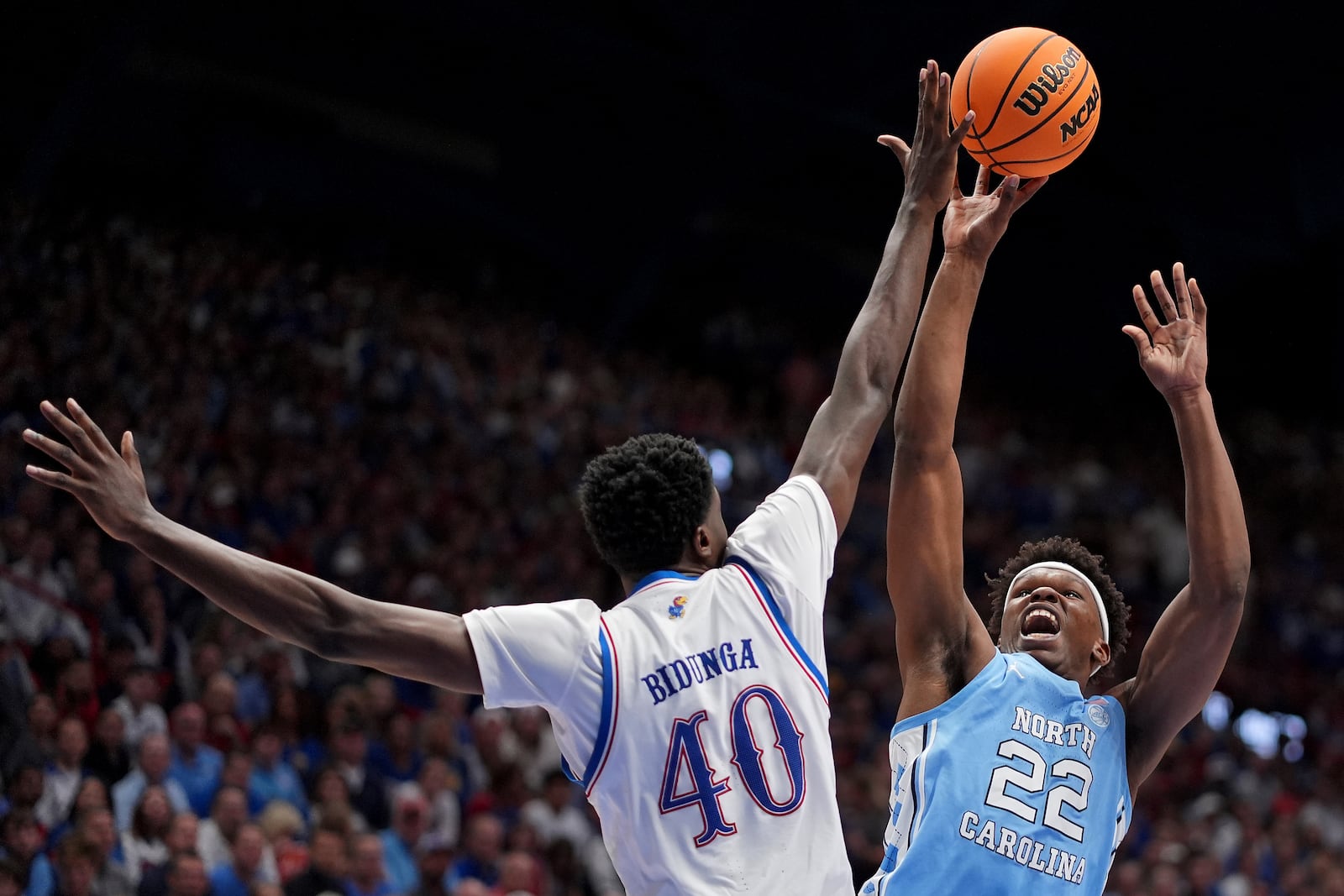 North Carolina forward Ven-Allen Lubin (22) shoots under pressure from Kansas forward Flory Bidunga (40) during the second half of an NCAA college basketball game Friday, Nov. 8, 2024, in Lawrence, Kan. Kansas won 92-89. (AP Photo/Charlie Riedel)