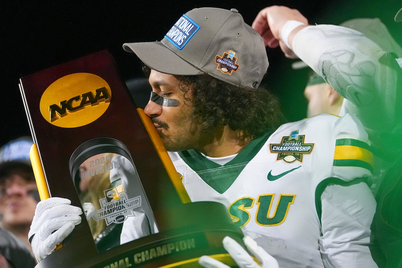 North Dakota State wide receiver Braylon Henderson kisses the trophy following the FCS Championship NCAA college football game against Montana State, Monday, Jan. 6, 2025, in Frisco, Texas. North Dakota State won 35-32. (AP Photo/Julio Cortez)