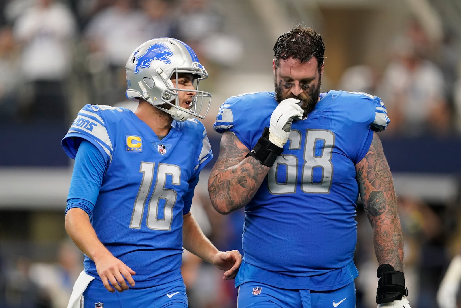 Detroit Lions quarterback Jared Goff (16) talks to offensive tackle Taylor Decker after running back Jamaal Williams fumbled at the 1-yard line during the second half of an NFL football game against the Dallas Cowboys, Sunday, Oct. 23, 2022, in Arlington, Texas. (AP Photo/Tony Gutierrez)