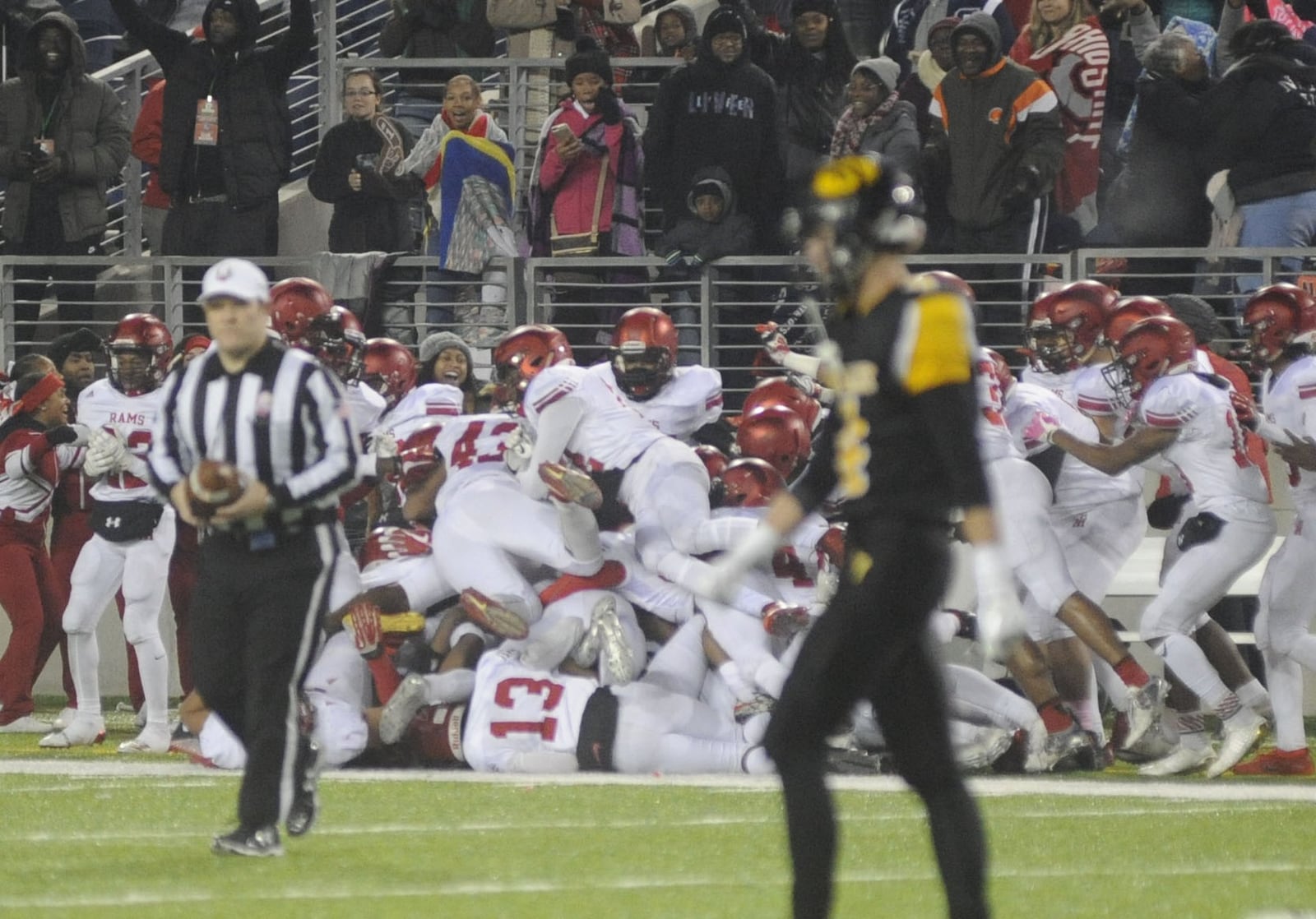 Trotwood teammates pile on Jayvanare Nelloms after his game-saving interception. Trotwood-Madison defeated Dresden Tri-Valley 27-19 to win a D-III state football title at Canton on Sat., Dec. 2, 2017. MARC PENDLETON / STAFF