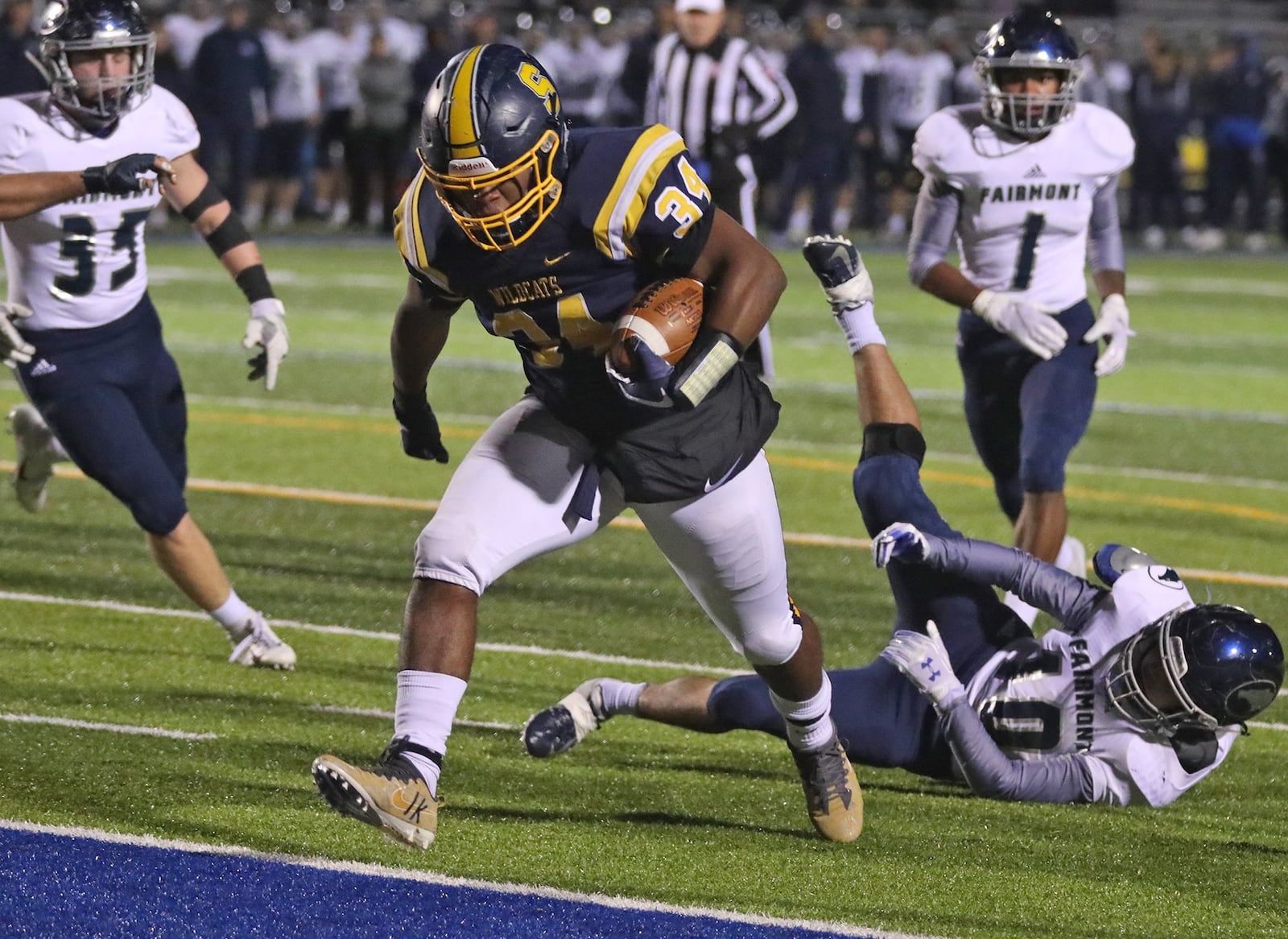 Springfield’s Tavion Smoot rushes for the Wildcats’ first touchdown against Fairmont on Friday night at Evans Stadium. BILL LACKEY/STAFF