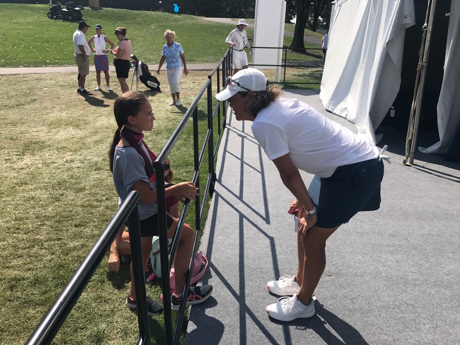 Centerville native Jamie Fischer talks to a young fan after finishing the final round of the U.S Senior Women's Open on Sunday at NCR Country Club. Tom Archdeacon/STAFF