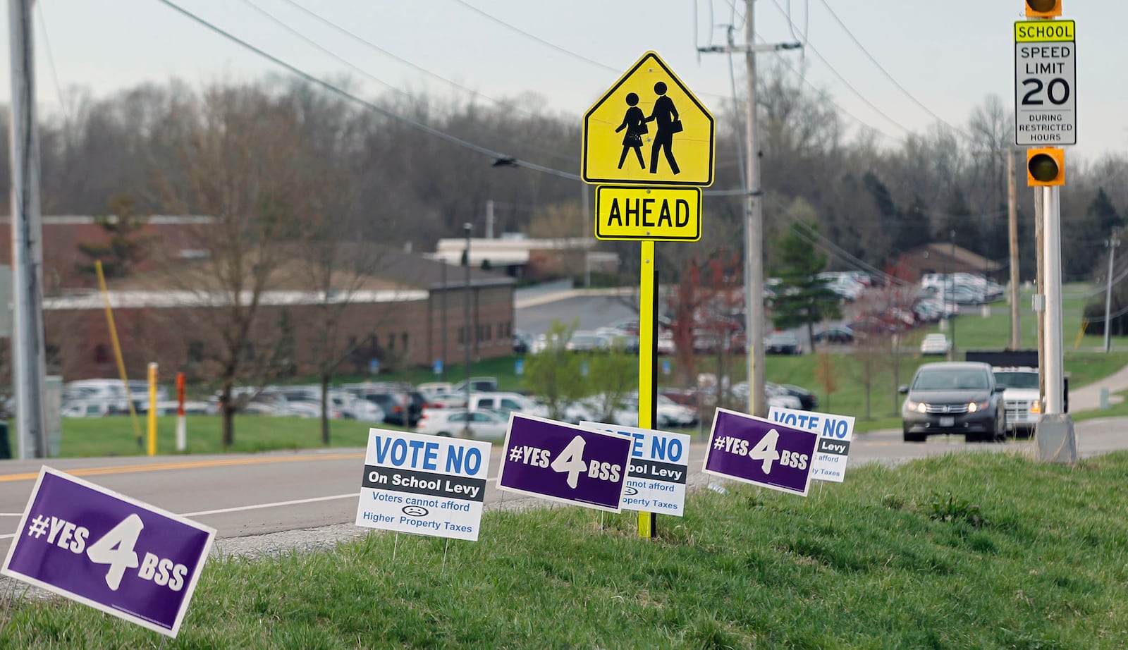 School levy campaign signs popped up like spring flowers everywhere in Bellbrook in April 2019, including this stretch at the corner of Upper Bellbrook and Feedwire Roads near Bellbrook High School. TY GREENLEES / STAFF