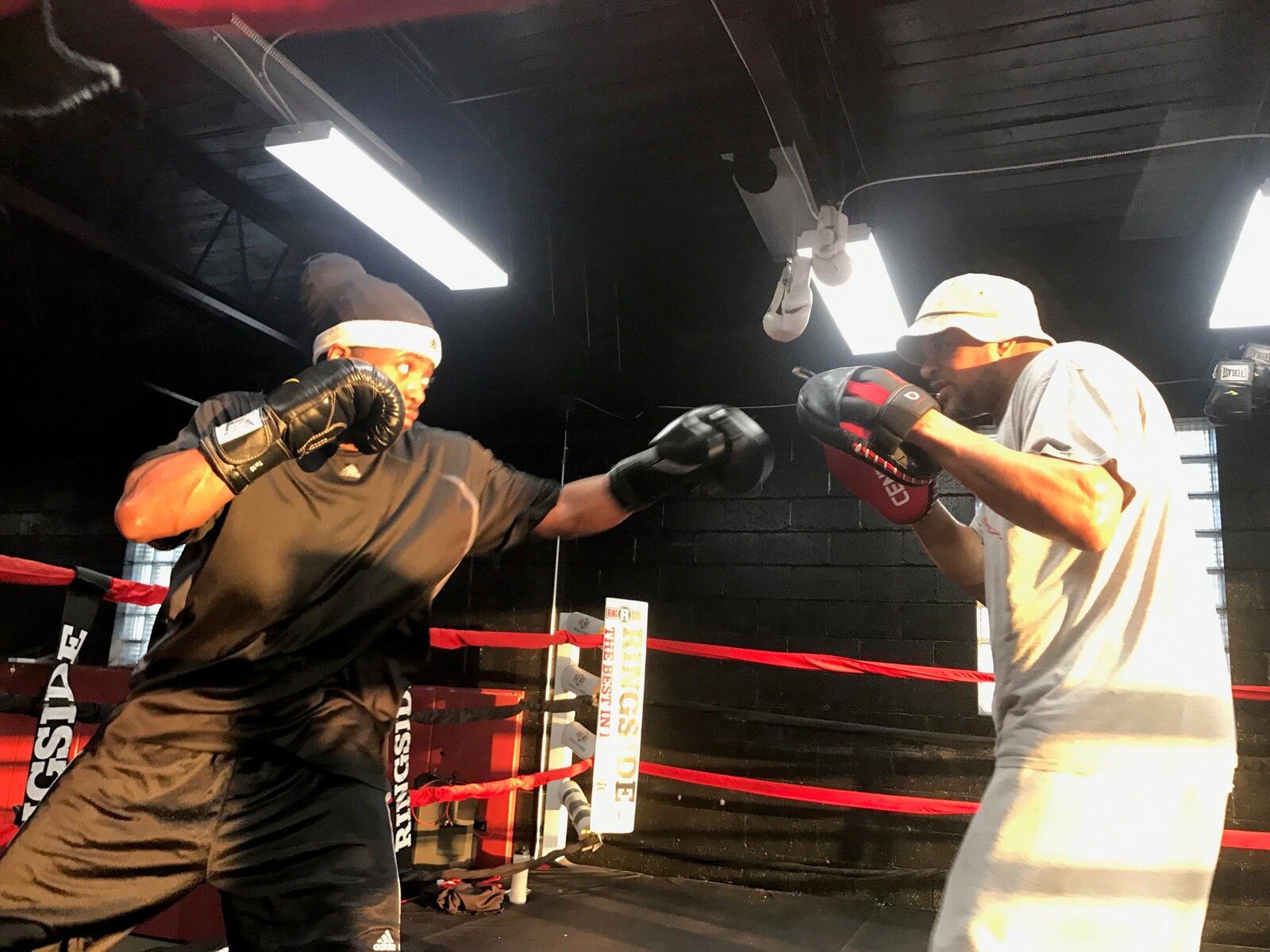 Mike Evans works with trainer Craig Thurmond during a mitt session at M-Power Gym in Vandalia. Tom Archdeacon/STAFF