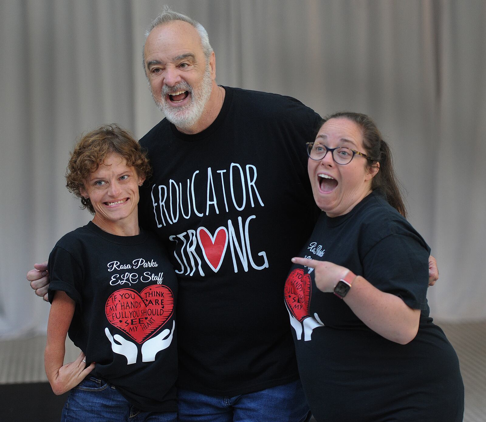 Dayton teachers Stephanie Miller, left, and Katy Philpot pose with Gerry Brooks, veteran educator and public speaker best known for his humorous social media videos, who spoke to DPS teachers at the Dayton Arcade as part of an optional summer professional development session on Wednesday, May 31, 2023. MARSHALL GORBY\STAFF