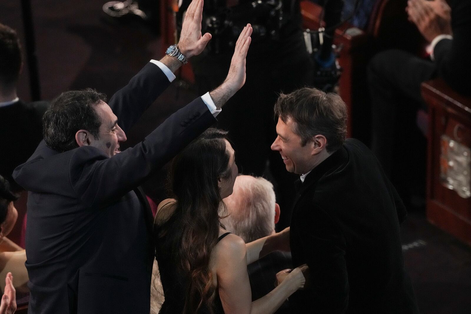 Karren Karagulian, from left, Samanthan Quan, and congratulate Sean Baker for winning the award for best film editing for "Anora" during the Oscars on Sunday, March 2, 2025, at the Dolby Theatre in Los Angeles. (AP Photo/Chris Pizzello)