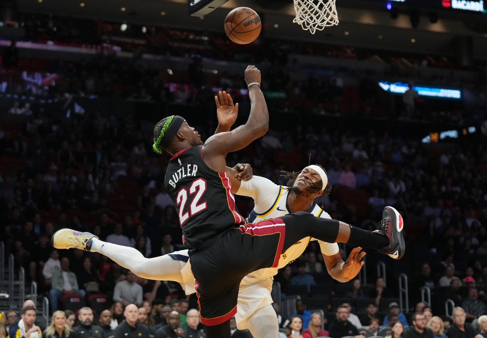 Miami Heat forward Jimmy Butler (22) goes to the basket as Indiana Pacers center Myles Turner, right, defends during the first half of an NBA basketball game Thursday, Jan. 2, 2025, in Miami. (AP Photo/Lynne Sladky)