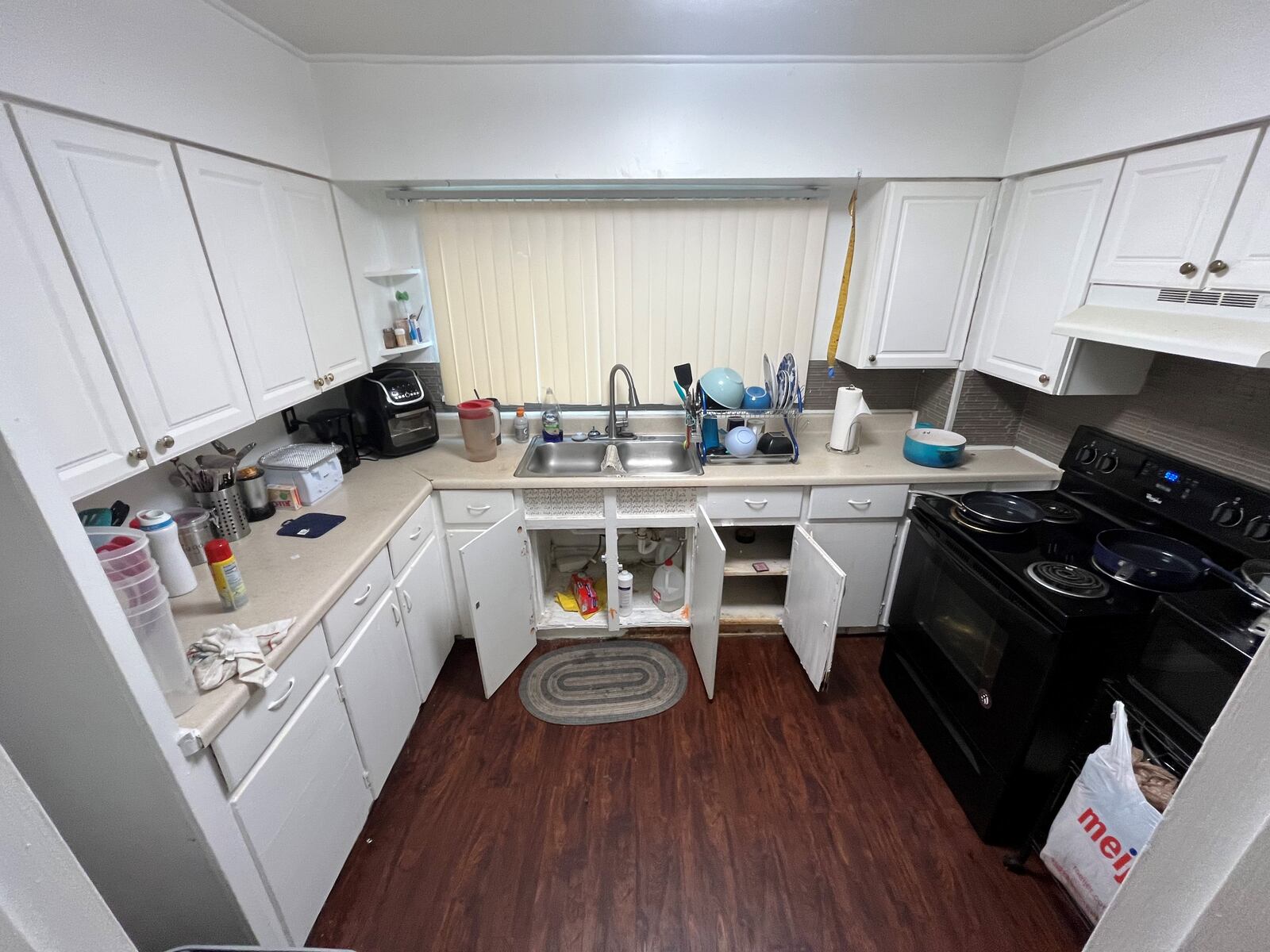 The kitchen of one of the units in the Rustic Arms apartments. The renter says she doesn't use her bottom cabinets because of rodents. CORNELIUS FROLIK / STAFF