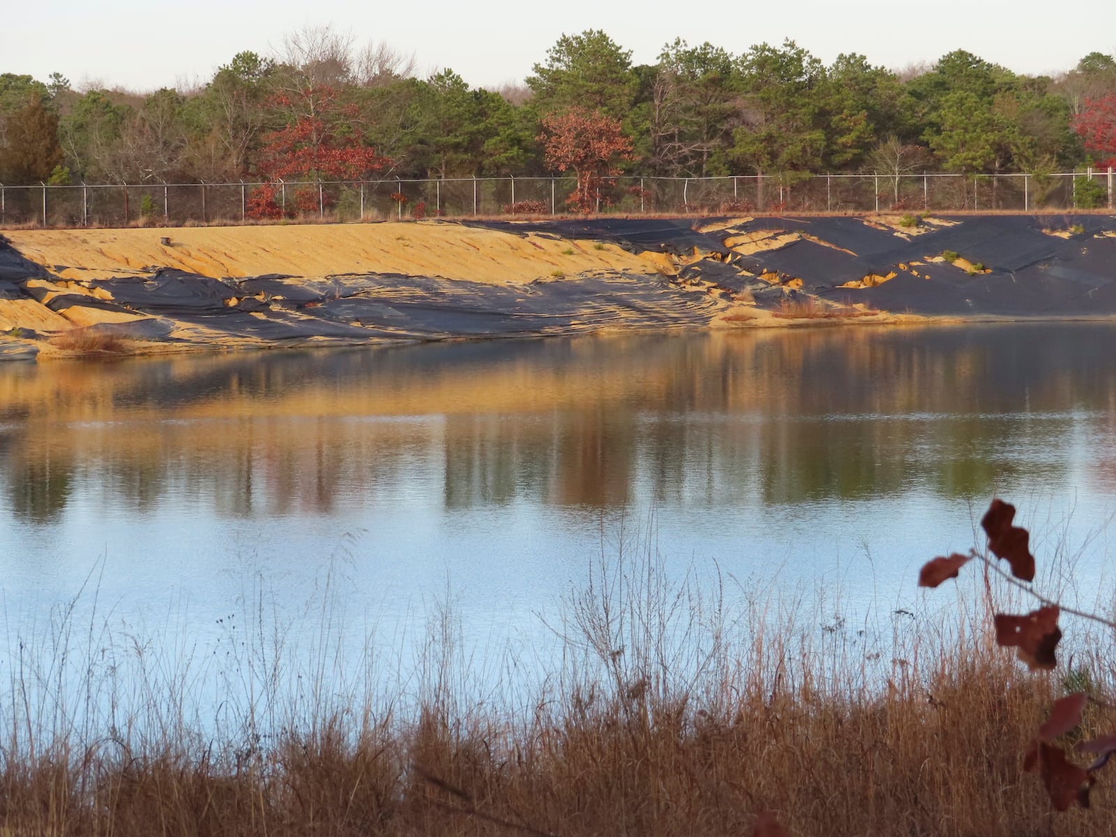 Water sits in a lined pit at the former Ciba-Geigy chemical plant on Dec. 17, 2024, in Toms River, N.J., one of America's most notorious toxic waste sites. (AP Photo/Wayne Parry)