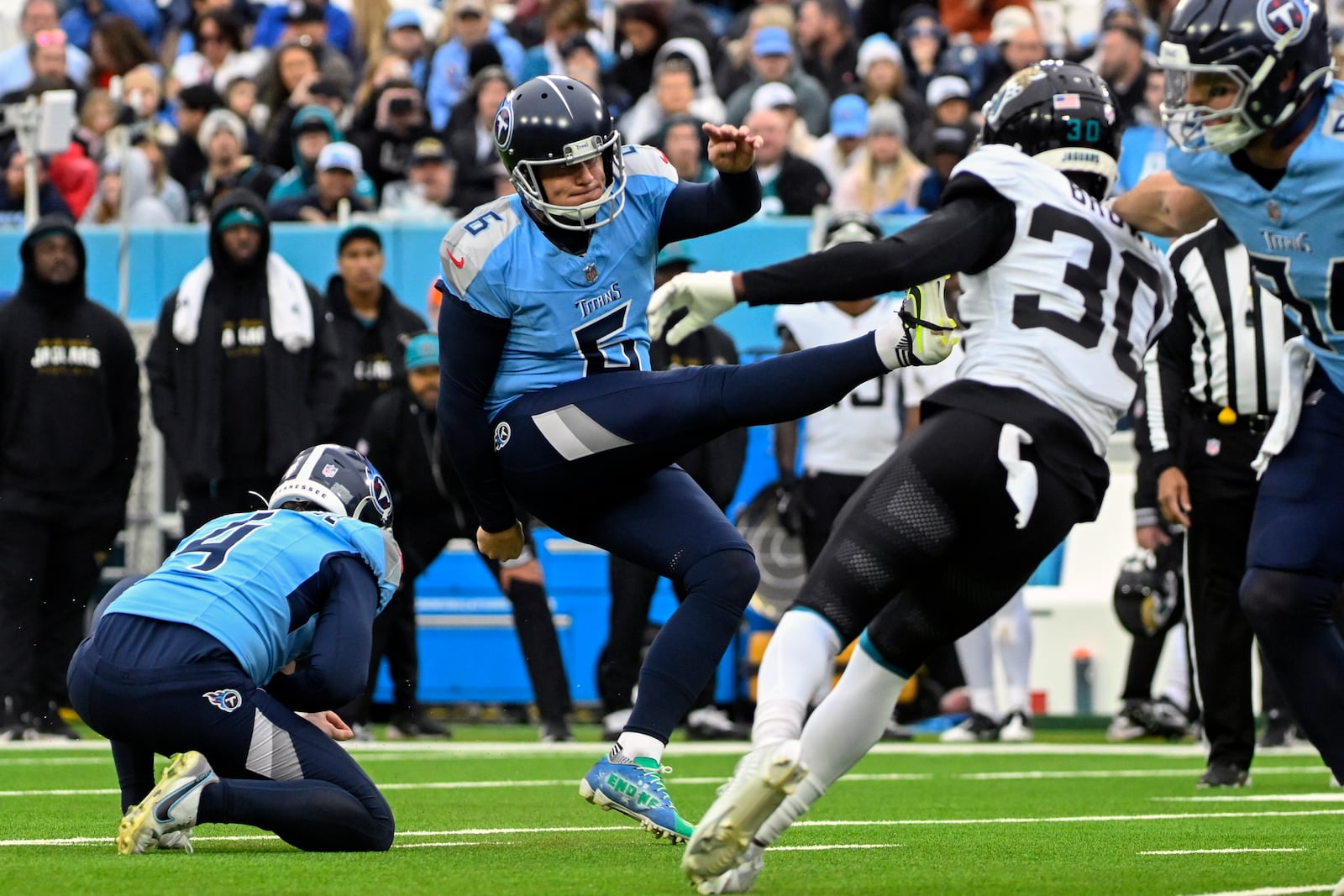 Tennessee Titans place kicker Nick Folk kicks a field goal against the Jacksonville Jaguars during the second half of an NFL football game, Sunday, Dec. 8, 2024, in Nashville, Tenn. (AP Photo/John Amis)