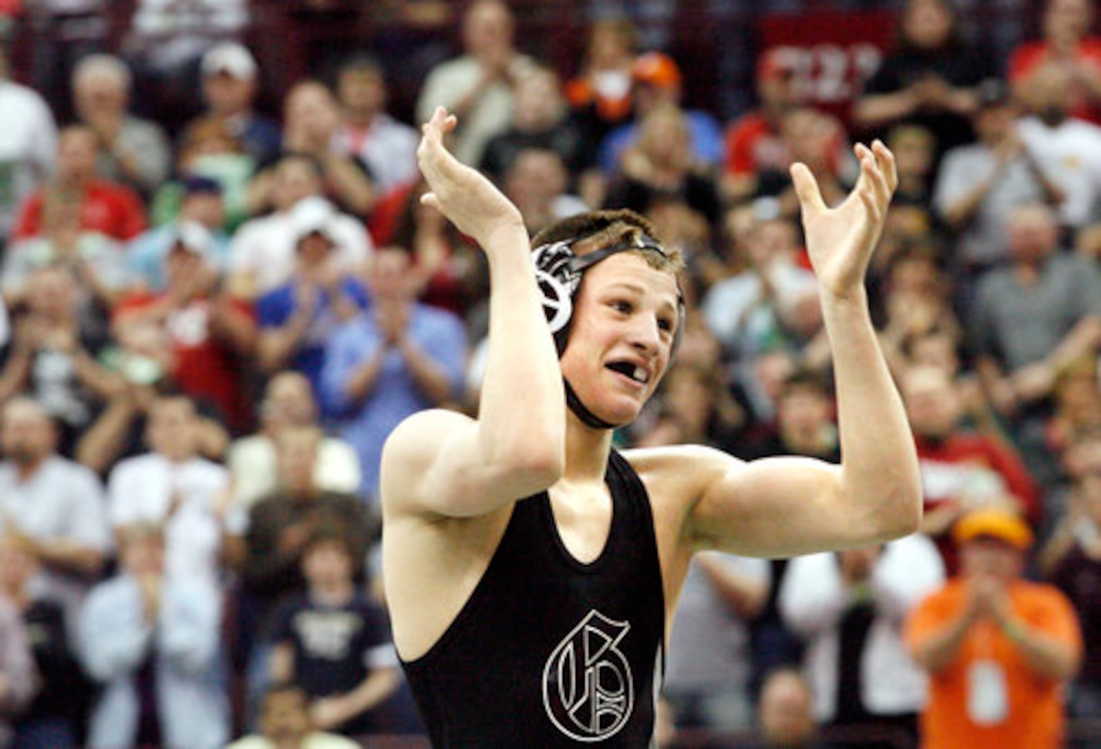 David Taylor of Graham claps as he receives a standing ovation from the crowd after defeating Manuel Cintron of Alliance at 135 lbs. to become a four-time Ohio state wrestling champion Saturday, March 7, 2009, at the Schottenstein Center in Columbus.