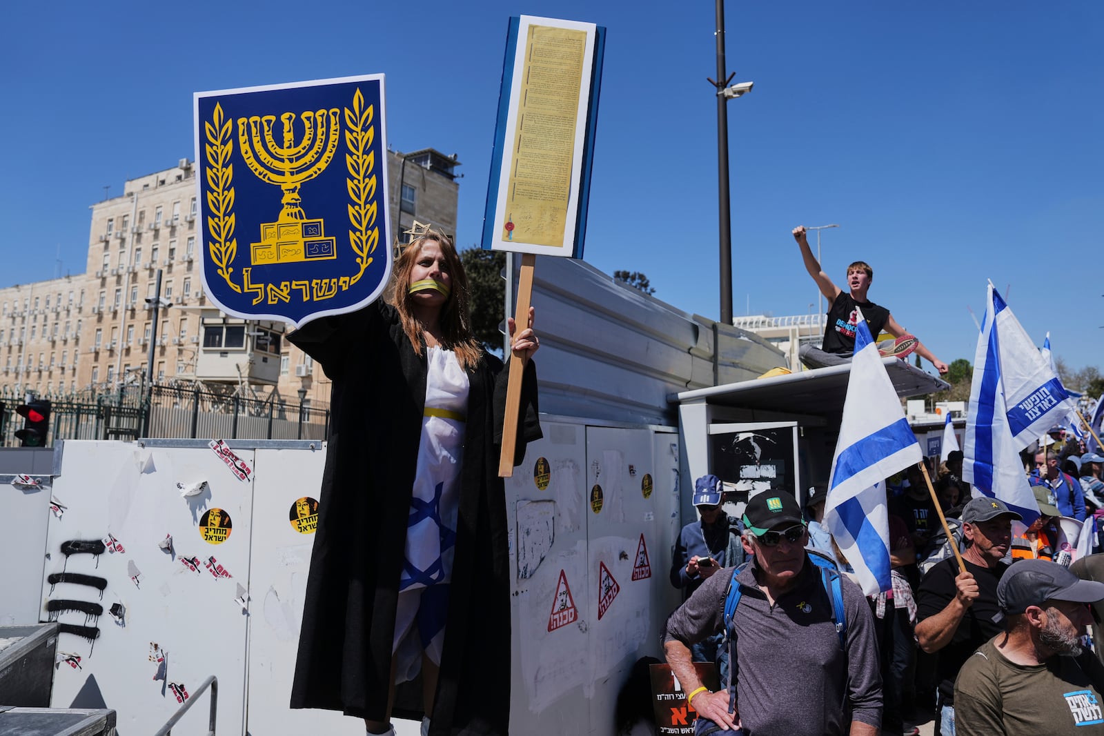 People protest a outside the Knesset, Israel's parliament, in Jerusalem on Sunday, March 23, 2025, as the Israeli cabinet is set to hold a no-confidence vote against Attorney General Gali Baharav-Miara. (AP Photo/Ohad Zwigenberg)