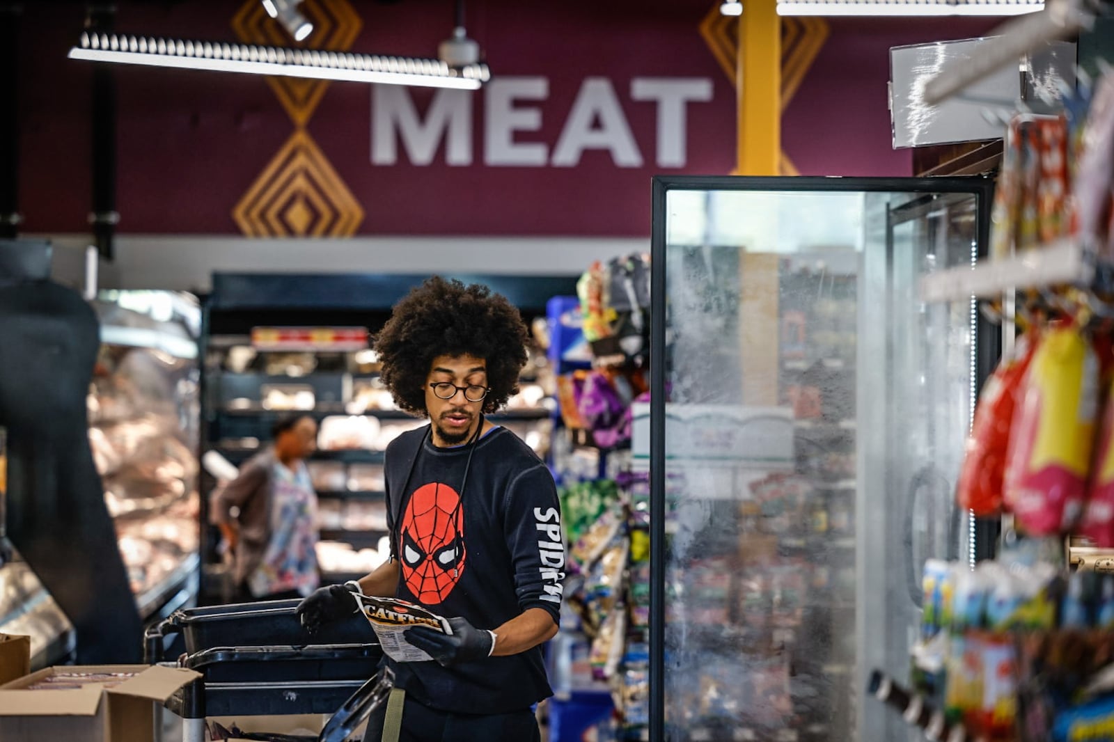 Gem City Market meat manager and butcher, Adrian Harris stocks the shelves Thursday morning September 21, 2023. The market has had a few tough years but plans to turn things around in the next few years. JIM NOELKER/STAFF