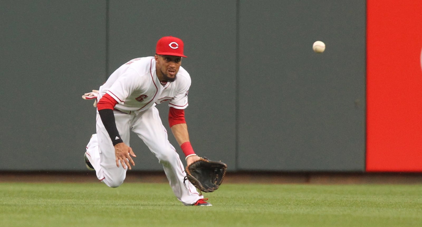 Reds center fielder Billy Hamilton dives but can’t catch a line drive against the Brewers on Friday, April 14, 2017, at Great American Ball Park in Cincinnati. David Jablonski/Staff