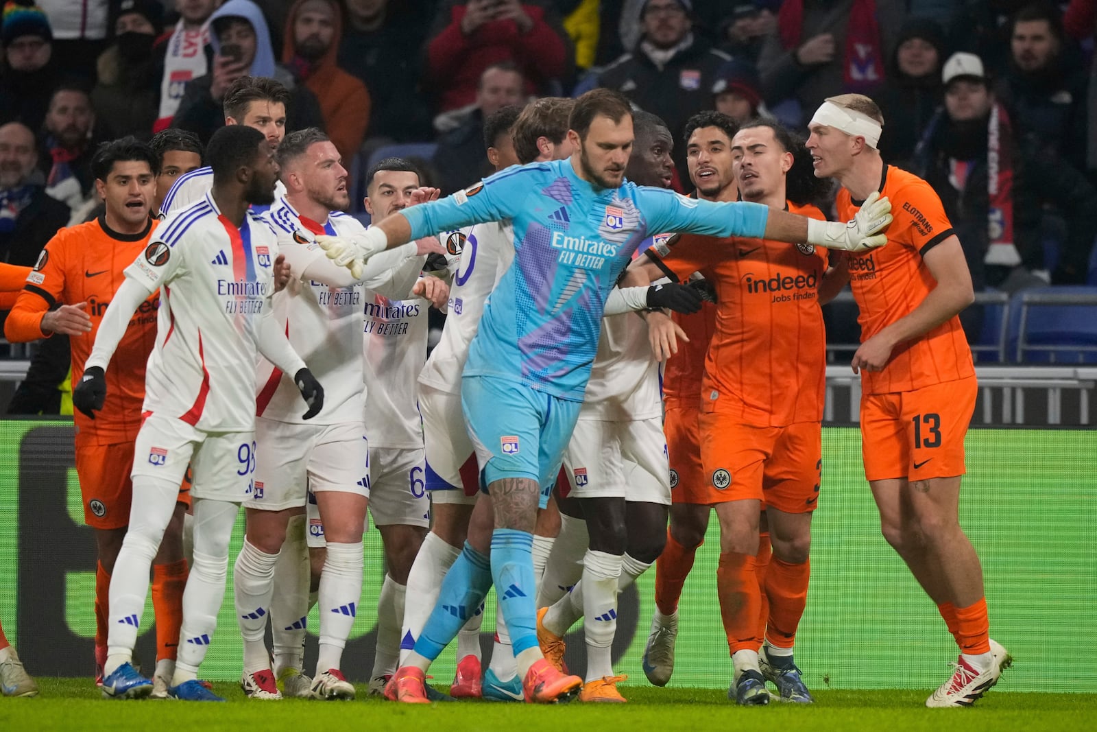 Frankfurt's Rasmus Kristensen, right, argues with Lyon's Tanner Tessmann, unseen, during the Europa League soccer match between Lyon and Eintracht Frankfurt at Decines stadium outside Lyon, France, Thursday, Dec. 12, 2024. (AP Photo/Michel Euler)