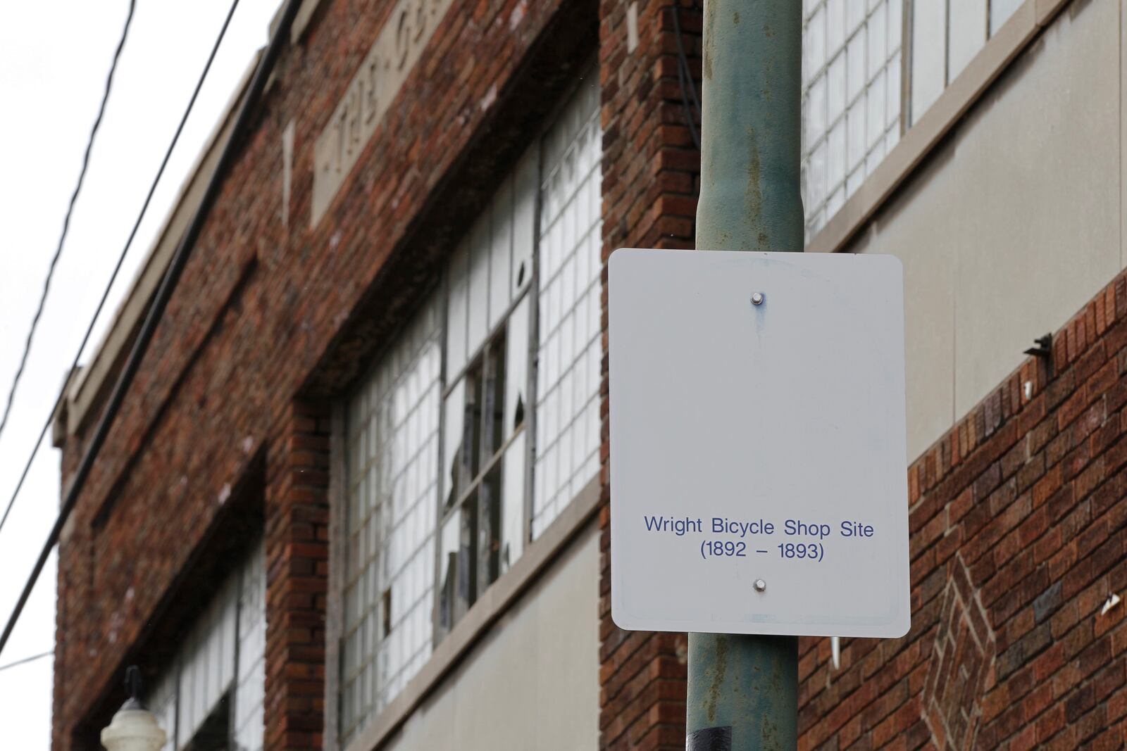 In this undated photo, a sign notes the site of the Wright brothers' bike shop outside the former Gem City Ice Cream building in Dayton, Ohio. The city of Dayton plans to demolish the 129-year-old historic building that once was the site of the Wright brothers’ first bike shop because the building has deteriorated and is unable to be maintained and redeveloped. The shop was first built in 1892 to serve as the Wright brothers' first bike shop. Soon thereafter, Gem City Ice Cream Co. bought the property and housed it until 1975 until was sold to another company, the Dayton Daily News reported. (Ty Greenlees/Dayton Daily News via AP, File)