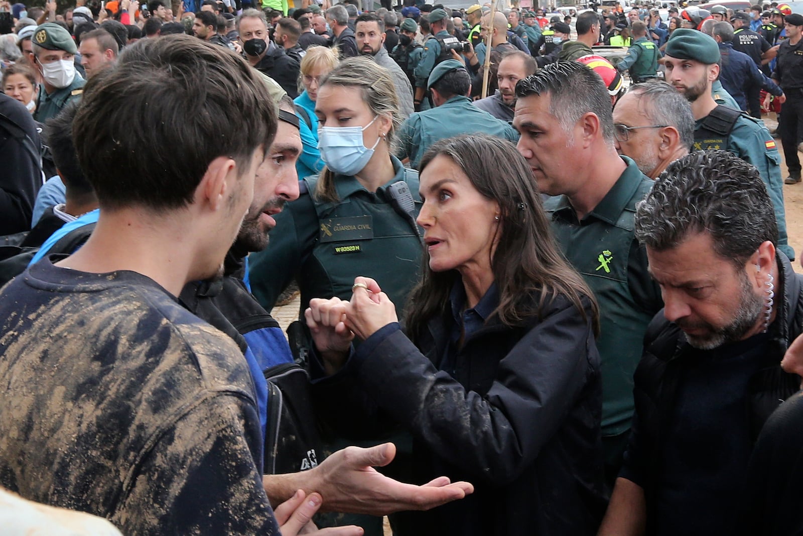 Spain's Queen Letizia speaks with people affected by the floods after crowd of angry survivors of Spain's floods tossed mud and shouted insults at the Spain's King Felipe and government officials when they made their first visit to one of the hardest hit towns. after floods in Paiporta near Valencia, Spain, Sunday, Nov. 3, 2024. (AP Photo/Hugo Torres)