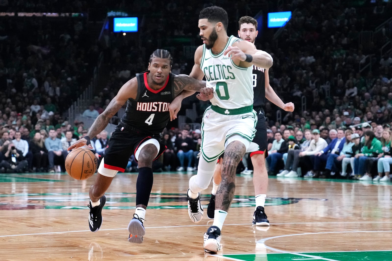 Houston Rockets guard Jalen Green (4) drives to the basket against Boston Celtics forward Jayson Tatum (0) during the first half of an NBA basketball game, Monday, Jan. 27, 2025, in Boston. (AP Photo/Charles Krupa)