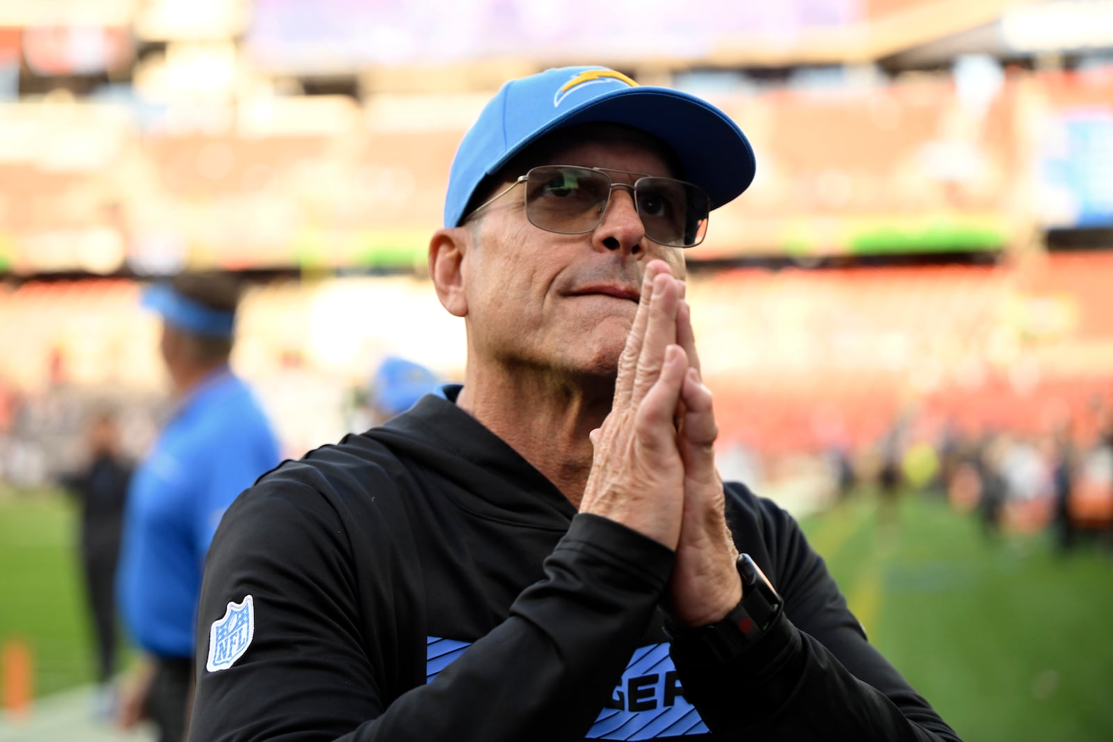 Los Angeles Chargers head coach Jim Harbaugh leaves the field after the Chargers beat the Cleveland Browns 27-10 in an NFL football game Sunday, Nov. 3, 2024, in Cleveland. (AP Photo/David Richard)