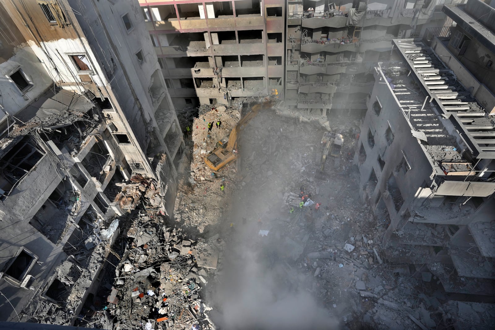 Rescue workers search for victims at the site of an Israeli airstrike that hit central Beirut, Lebanon, Saturday, Nov. 23, 2024. (AP Photo/Hussein Malla)