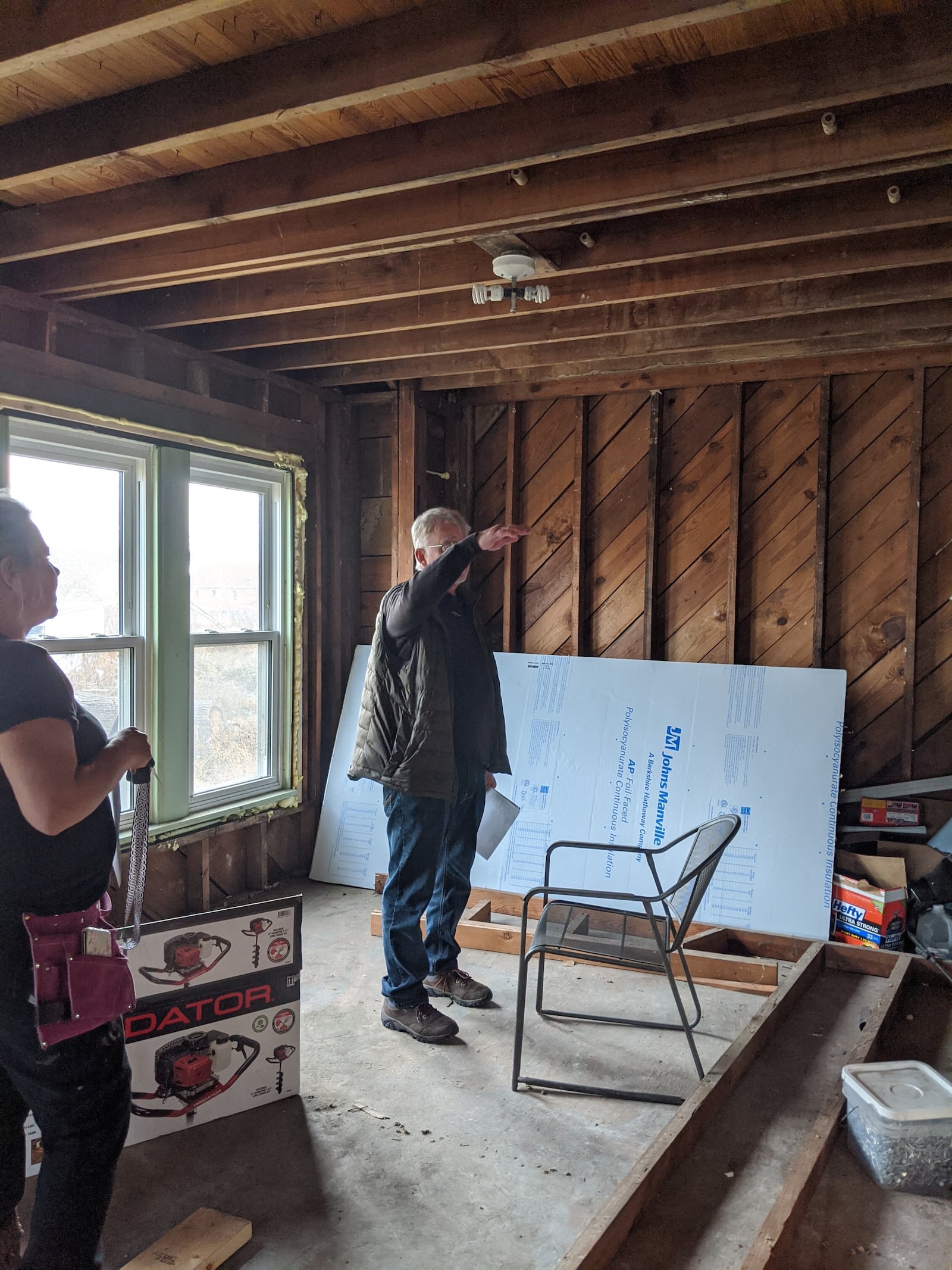 Repair work has continues at Robin and Chris Sassenberg's home (pictured on the right) in Dayton. Much progress has happened since the Memorial Day tornadoes. The couple purchased the home on the left.  Chris Sassenberg is pictured in an upstairs space.