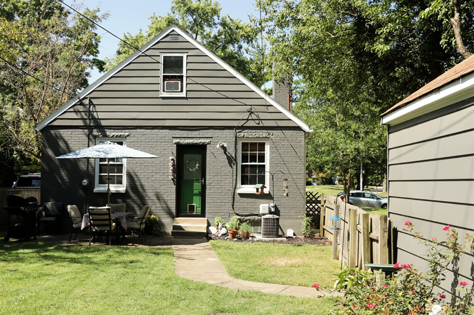 The back door opens to a paver-brick patio and a deep back yard with no rear neighbors. The privacy fence wraps around most of the yard with a shorter wooden fence that runs along the driveway. CONTRIBUTED PHOTO BY KATHY TYLER