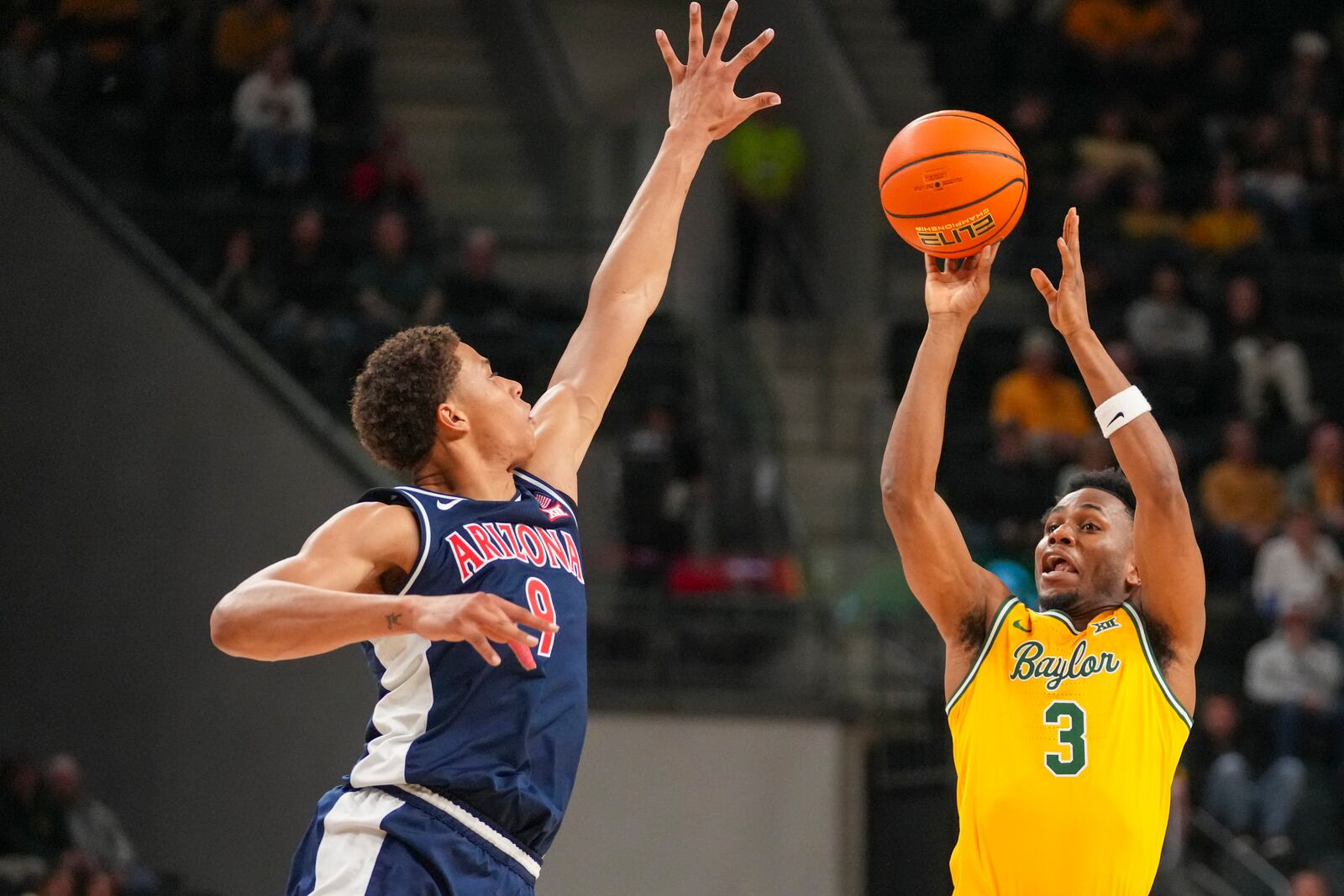 Baylor guard Jeremy Roach (3) shoots against Arizona forward Carter Bryant (9) during the first half of an NCAA college basketball game Monday, Feb. 17, 2025, in Waco, Texas. (AP Photo/Julio Cortez)