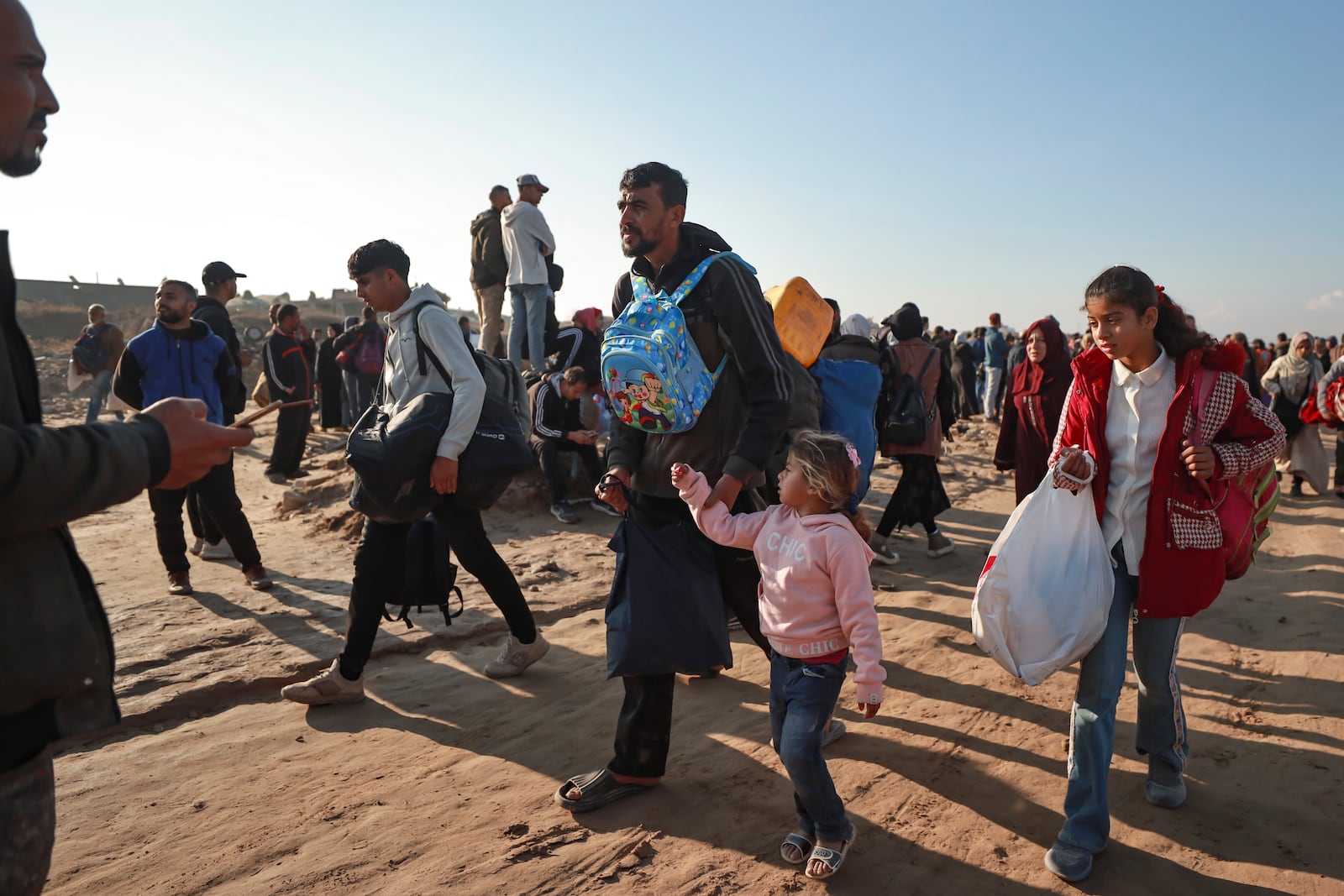 Displaced Palestinians arrive in the northern Gaza Strip, following Israel's decision to allow thousands of them to go back for the first time since the early weeks of the 15-month war with Hamas, Monday, Jan. 27, 2025. (AP Photo/Abed Hajjar)