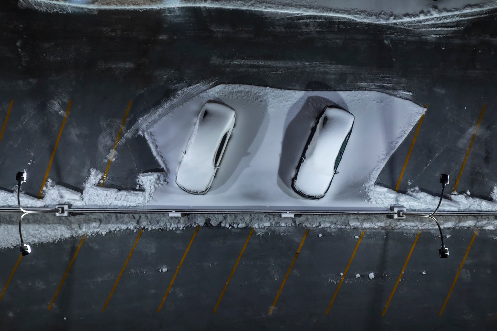 Snow covers vehicles parked at the Helix Garage in downtown Lexington, Ky., on Monday, Jan. 6, 2025. (Ryan C. Hermens/Lexington Herald-Leader via AP)