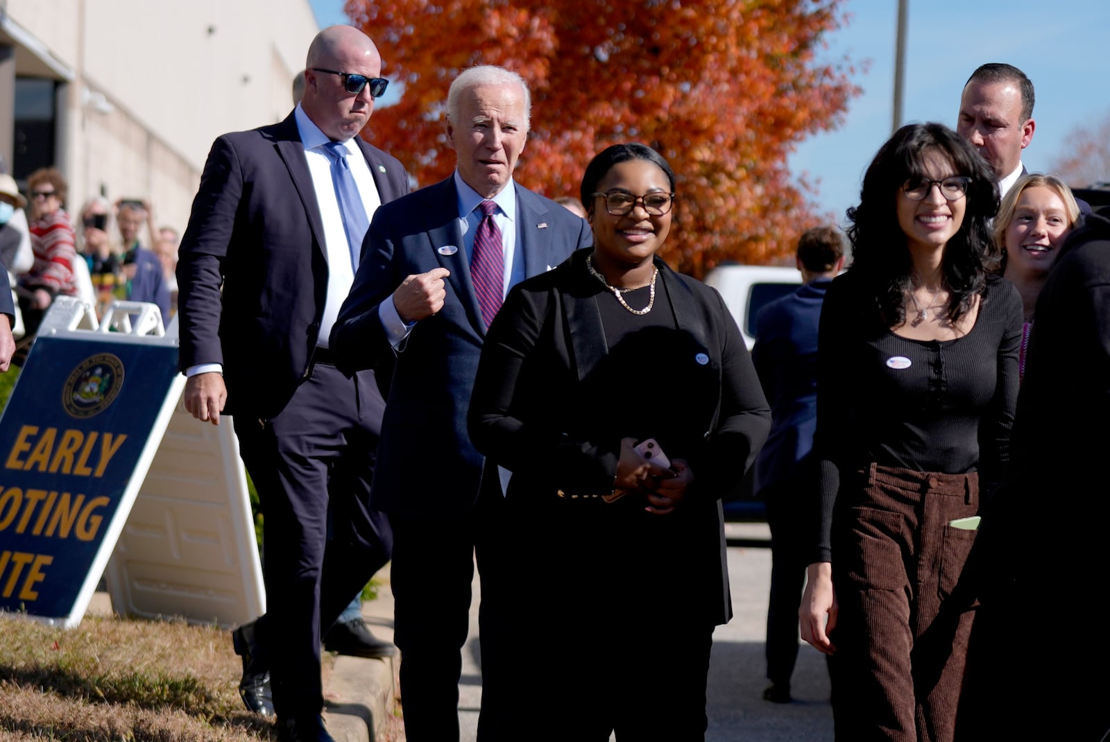 President Joe Biden, second left, departs a polling station alongside first-time voters after casting his early-voting ballot for the 2024 general elections, Monday, Oct. 28, 2024, in New Castle, Del. (AP Photo/Manuel Balce Ceneta)