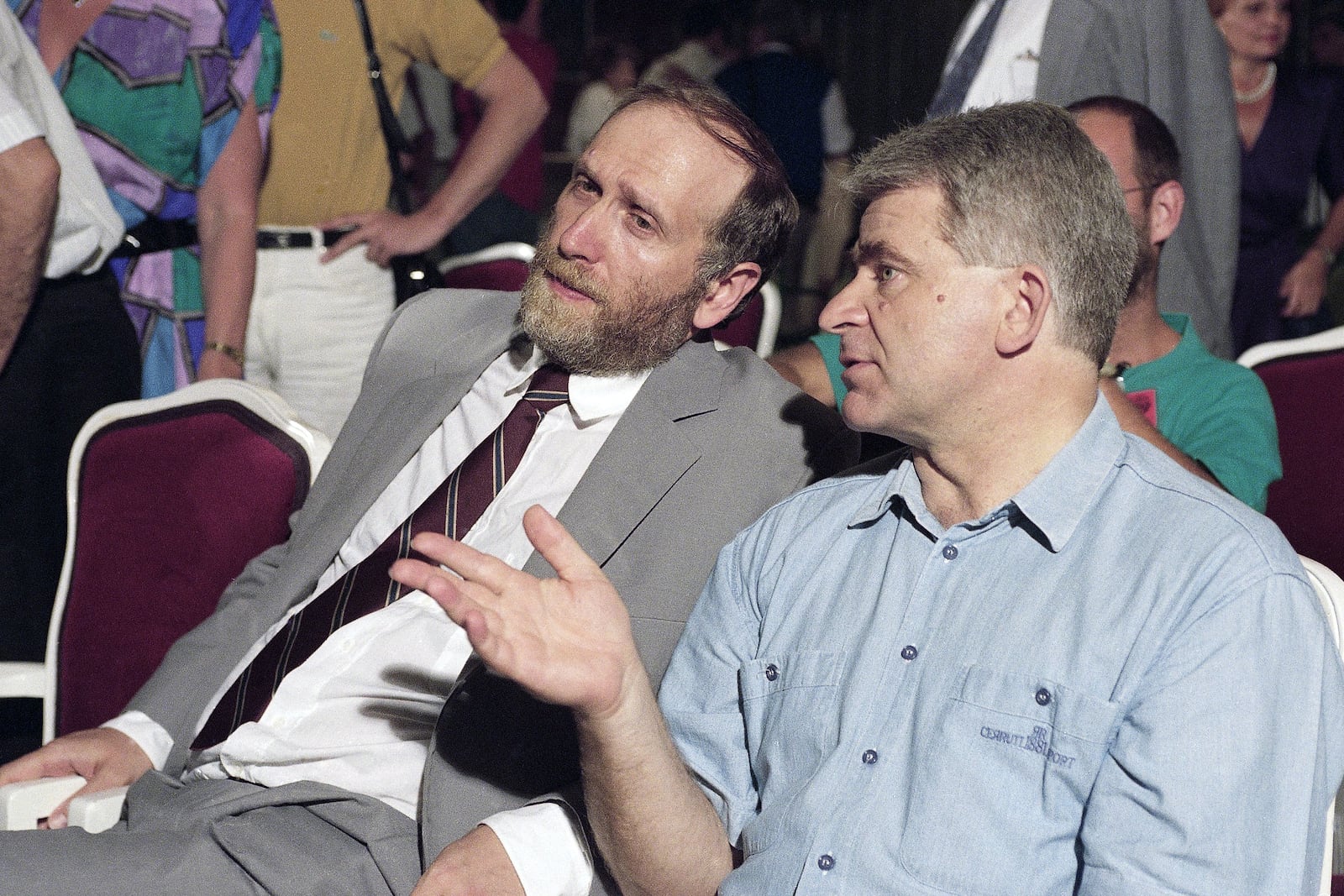 FILE- Bobby Fischer, left, and Boris Spassky discuss a point at a cocktail party after a news conference, Monday, Sept. 15, 1992 in Sveti Stefan, Yugoslavia. (AP Photo/File)