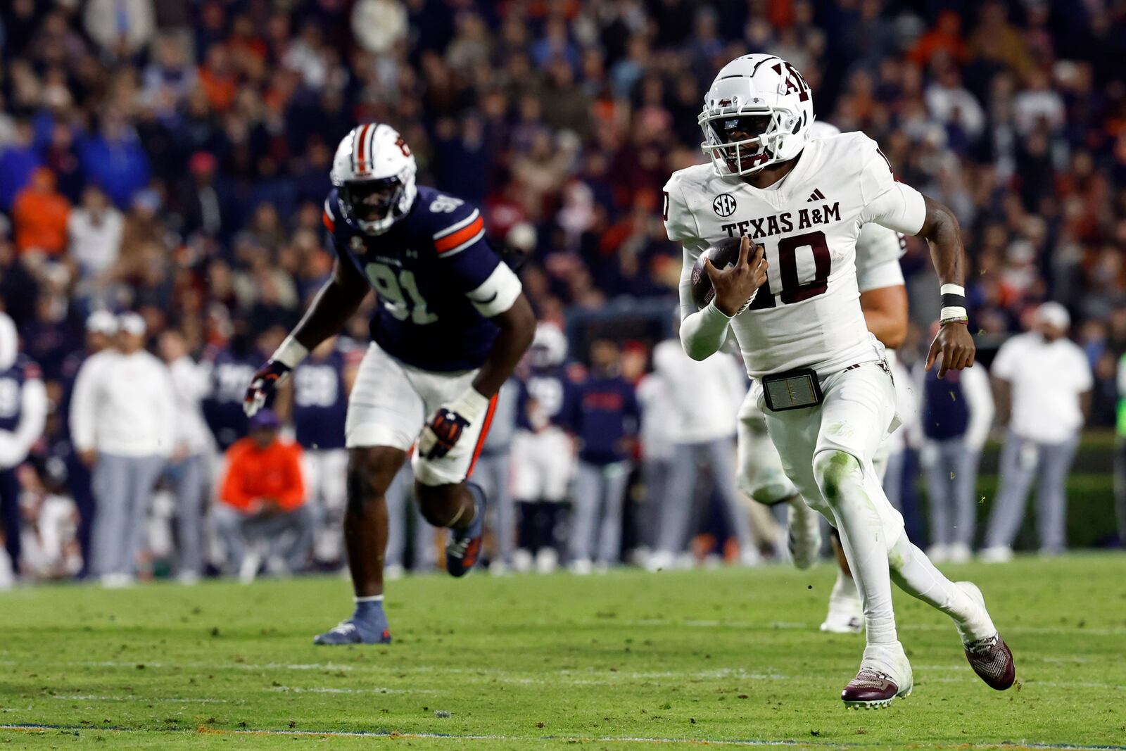 Texas A&M quarterback Marcel Reed (10) carries the ball for a first down against Auburn during the second half of an NCAA college football game, Saturday, Nov. 23, 2024, in Auburn, Ala. (AP Photo/Butch Dill)