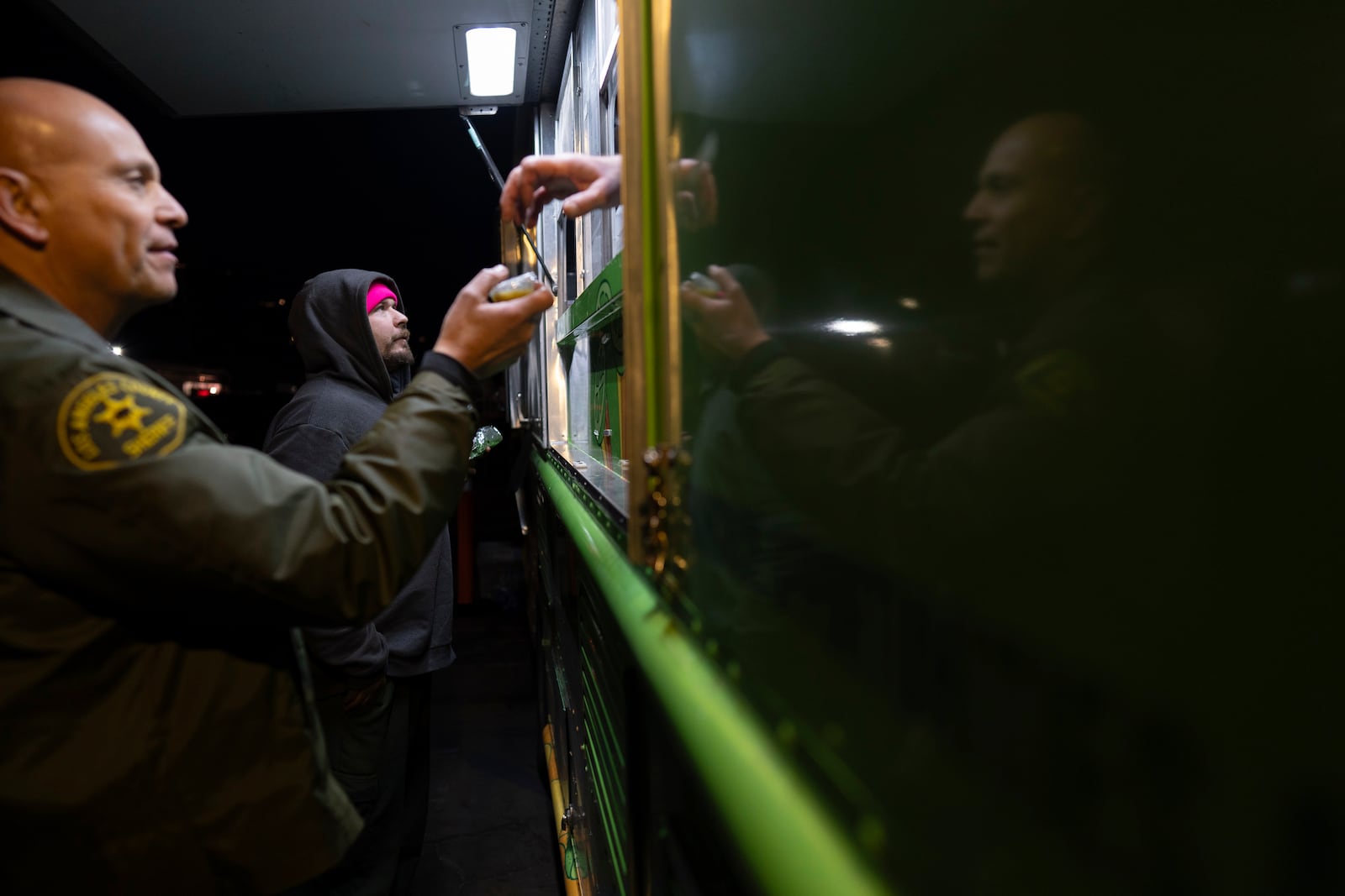 World Central Kitchen Chef Corp member Daniel Shemtob and Benton Atkisson serve Eaton Fire first responders from Shemtob's food truck, The Lime Truck, at the Rose Bowl Stadium, Wednesday, Jan. 15, 2025, in Pasadena, Calif. (AP Photo/Carolyn Kaster)