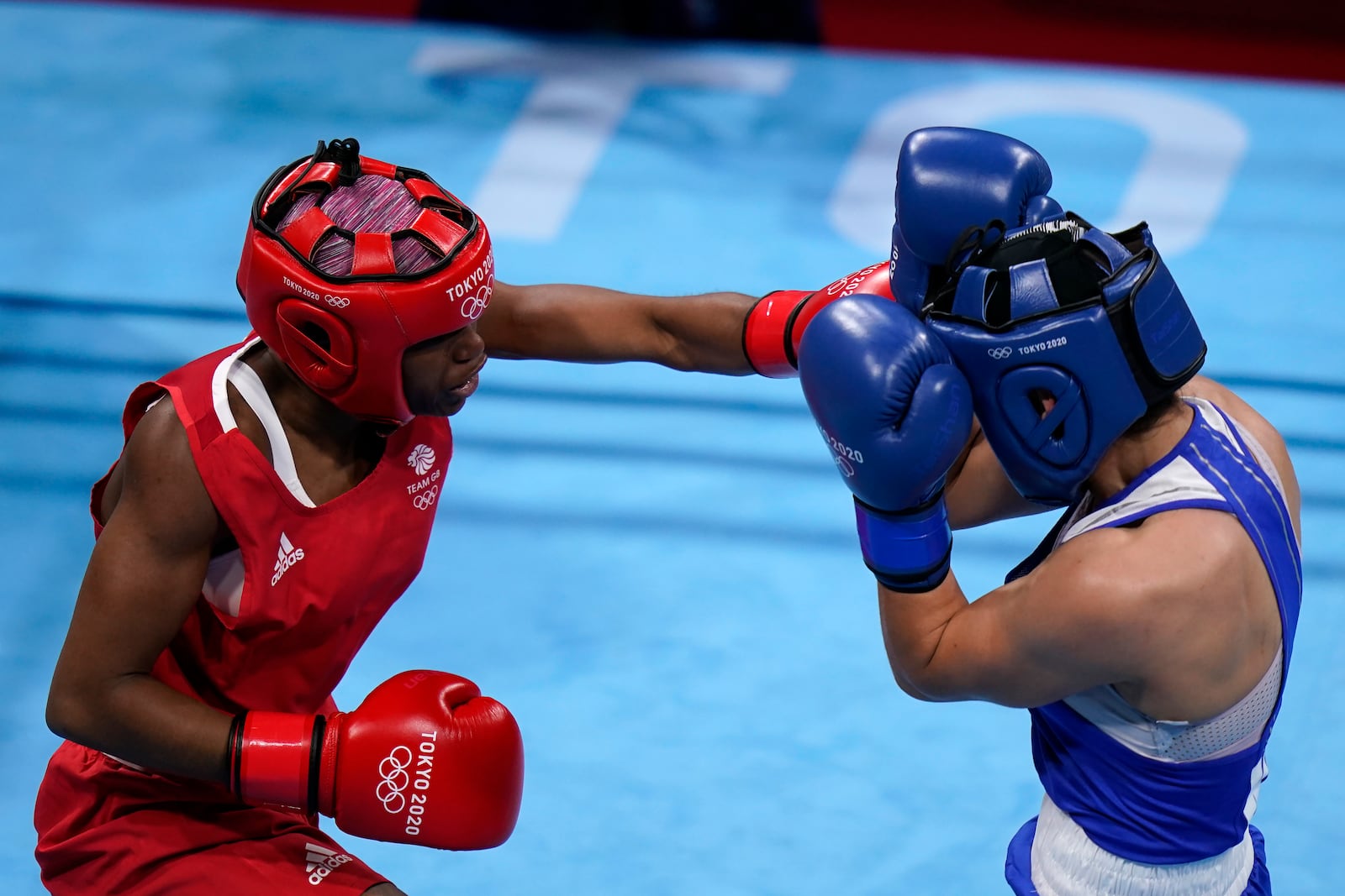 FILE -Caroline Dubois, of Great Britain, left, punches Donjeta Sadiku, of Kosovo, during their light weight (60kg) preliminary boxing match at the 2020 Summer Olympics, July 27, 2021, in Tokyo, Japan. (AP Photo/ Frank Franklin II), File)