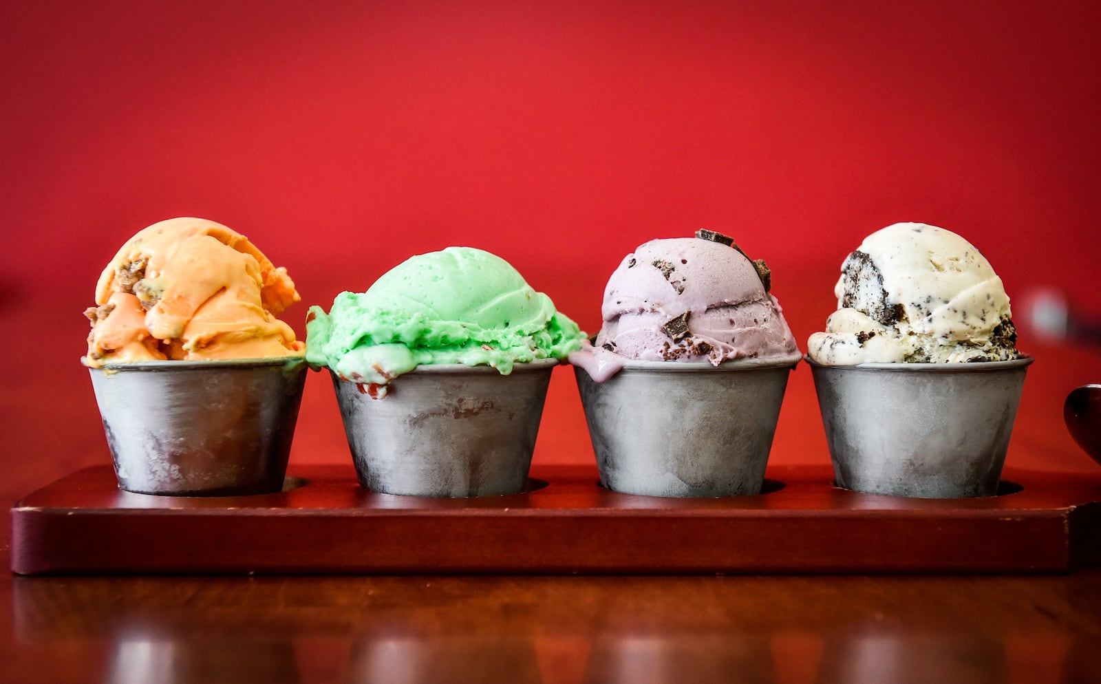 Craft Creamworks on Dudley Drive in West Chester Township is now open. This is their ice cream flight offering a chance to try four different flavors. Pictured left to right, peach cobbler, spumoni, black raspberry chocolate chip and peanut butter oreo flavors. NICK GRAHAM/STAFF