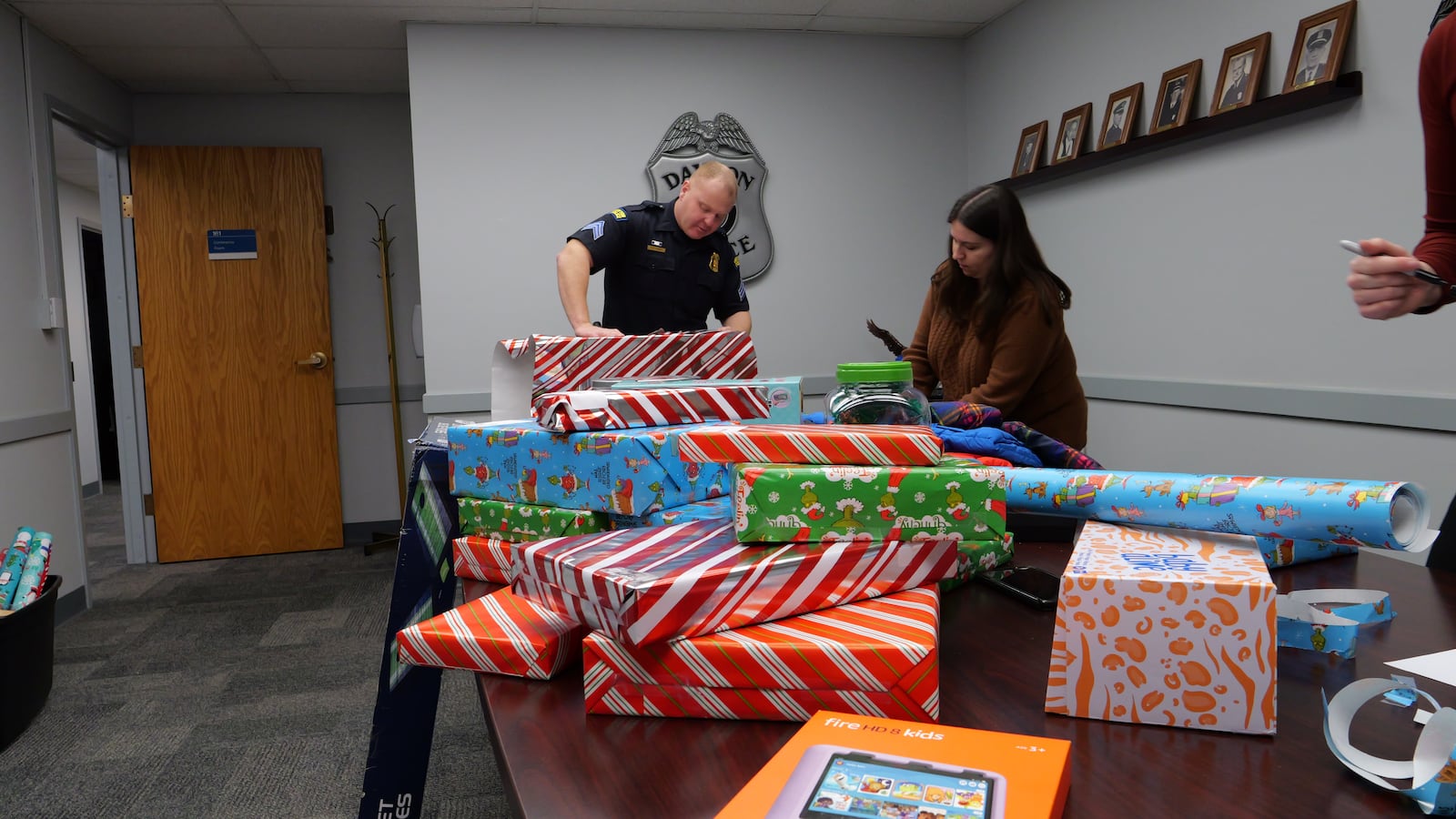 The Dayton Police Department wraps presents for its Angel Tree. The department "adopted" 12 families this year and bought them presents to help spread holiday cheer. Bikes, scooters, basketballs and clothes were popular gifts this year, Dayton police Sgt. Danielle Cash said. Photo courtesy Dayton Police Department.