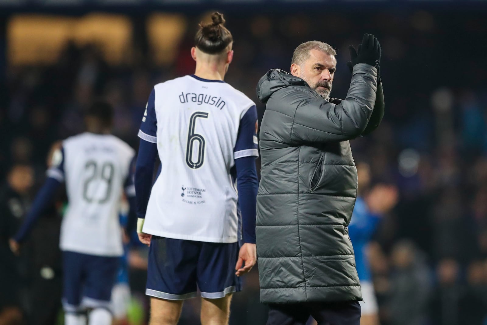 Tottenham's head coach Ange Postecoglou applauds the crowd after the Europa League opening phase soccer match between Glasgow Rangers and Tottenham Hotspur at Ibrox stadium in Glasgow, Thursday, Dec. 12, 2024. (AP Photo/Scott Heppell)