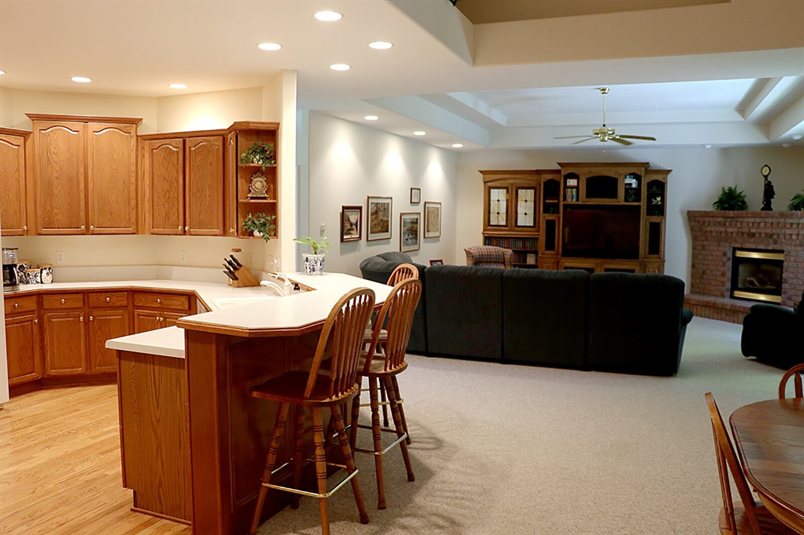 Straight off the foyer, the hallway opens into a combined great room and breakfast area, each with its own ceiling treatment. The great room has a double tray ceiling and tucked into one corner is a brick, gas fireplace with a raised brick hearth and hickory mantle shelf. CONTRIBUTED PHOTO BY KATHY TYLER