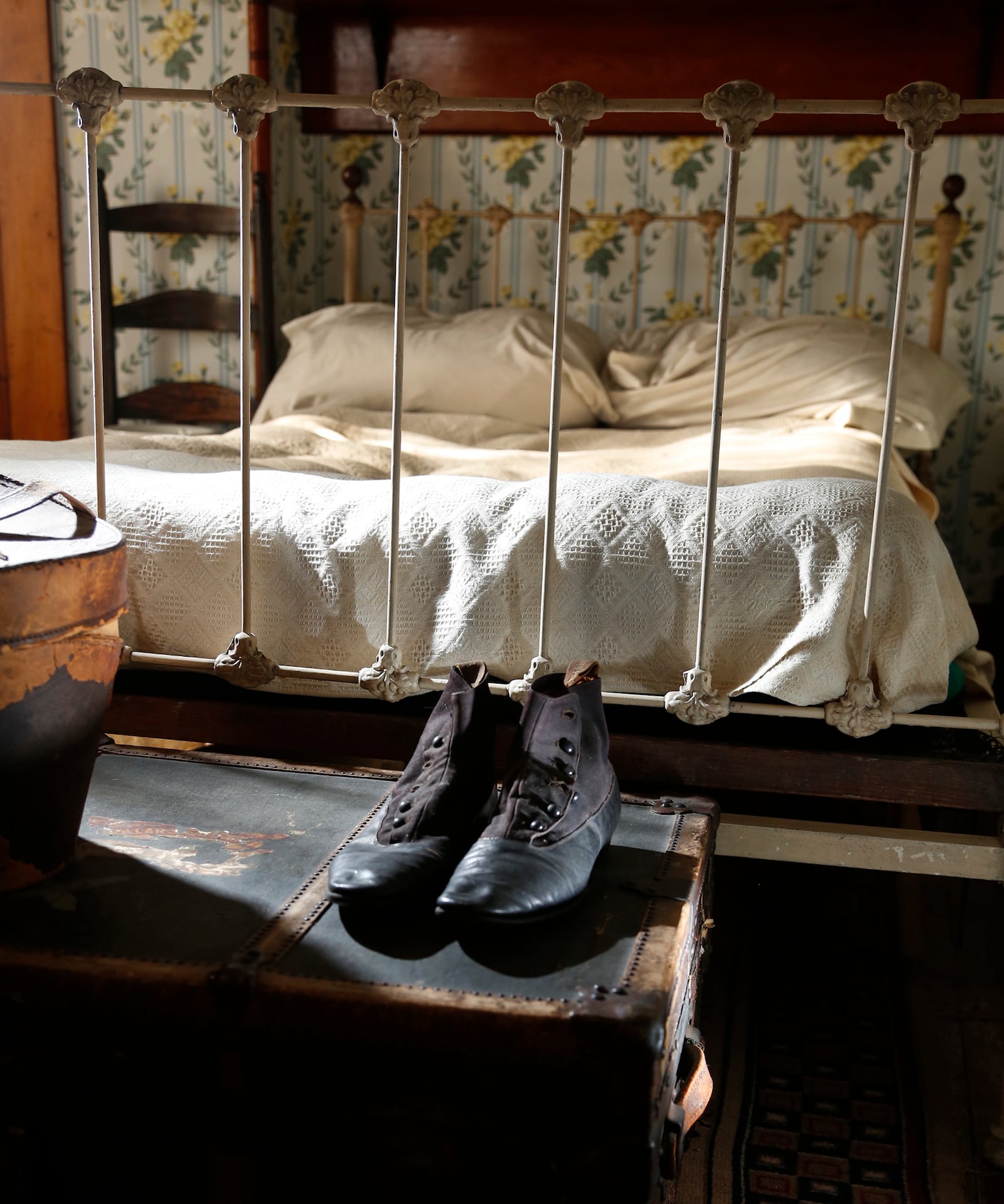 All the items in Dunbar's bedroom in the Paul Laurence Dunbar House are original. A pair of his shoes sits on top of his traveling trunk at the foot of his bed. LISA POWELL