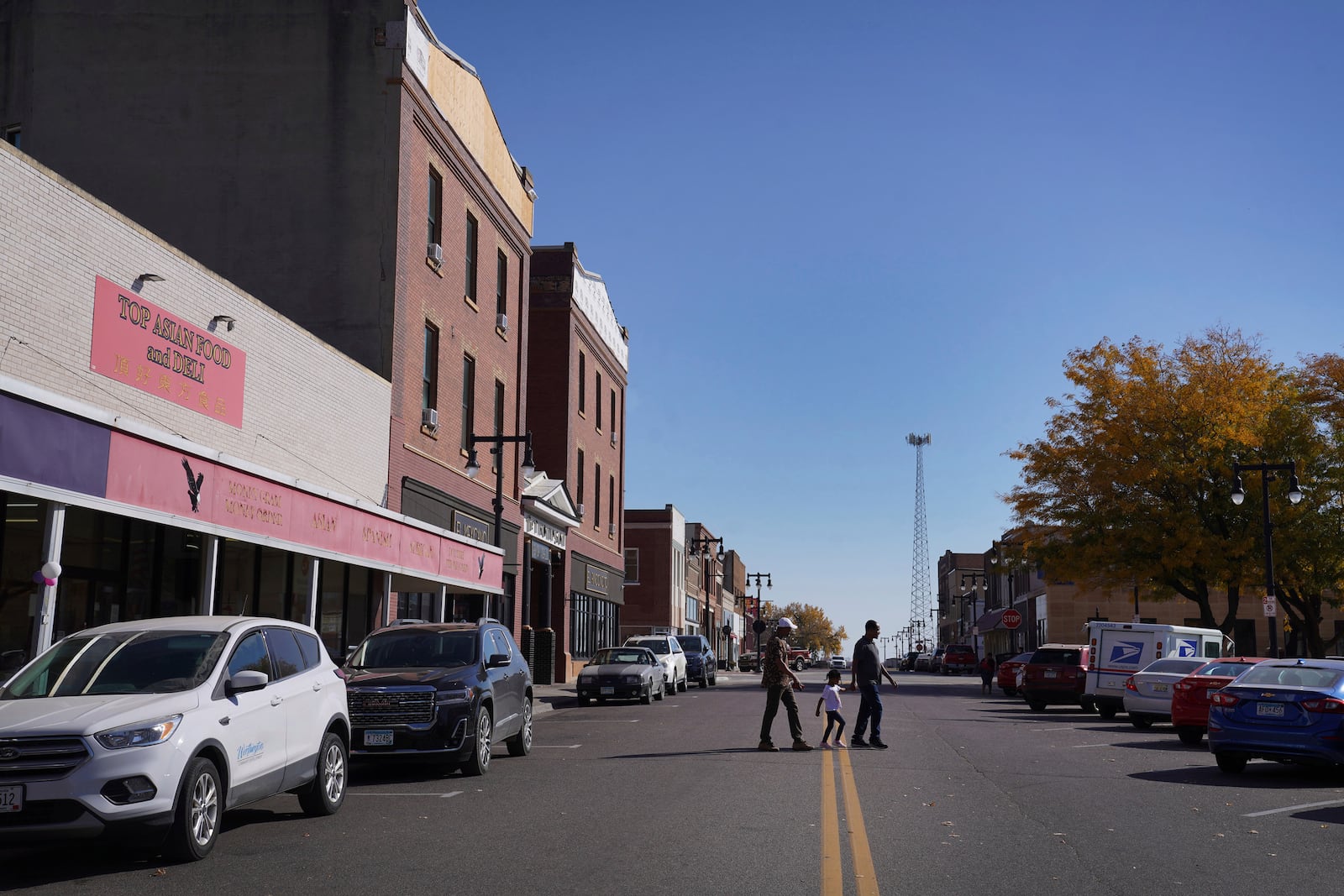 People walk through downtown Worthington, Minn., on Tuesday, Oct. 22, 2024. (AP Photo/Jessie Wardarski)