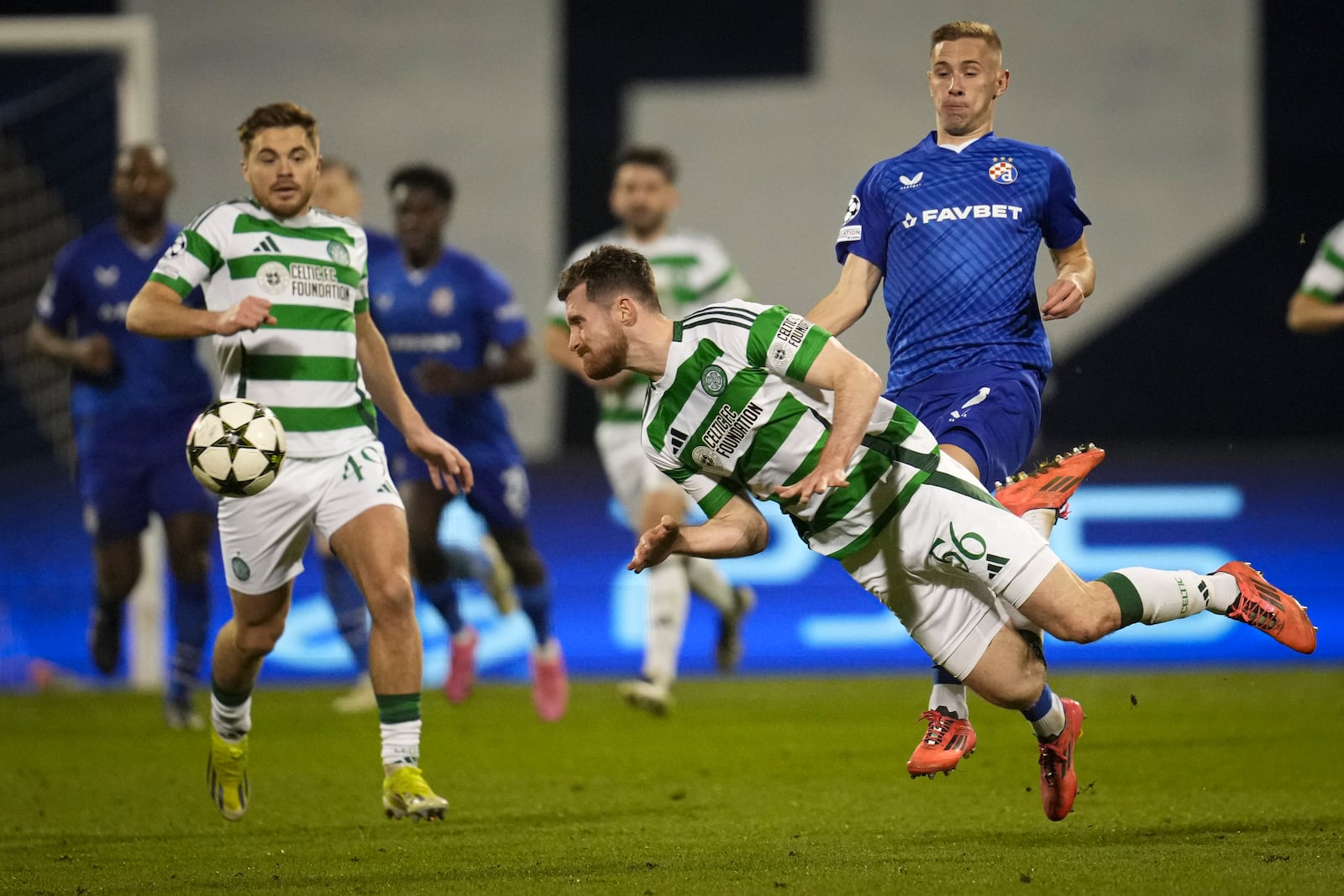 Celtic's Anthony Ralston dives to intercept the ball during the Champions League opening phase soccer match between Dinamo Zagreb and Celtic, at Maksimir stadium in Zagreb, Croatia, Tuesday, Dec. 10, 2024. (AP Photo/Darko Vojinovic)