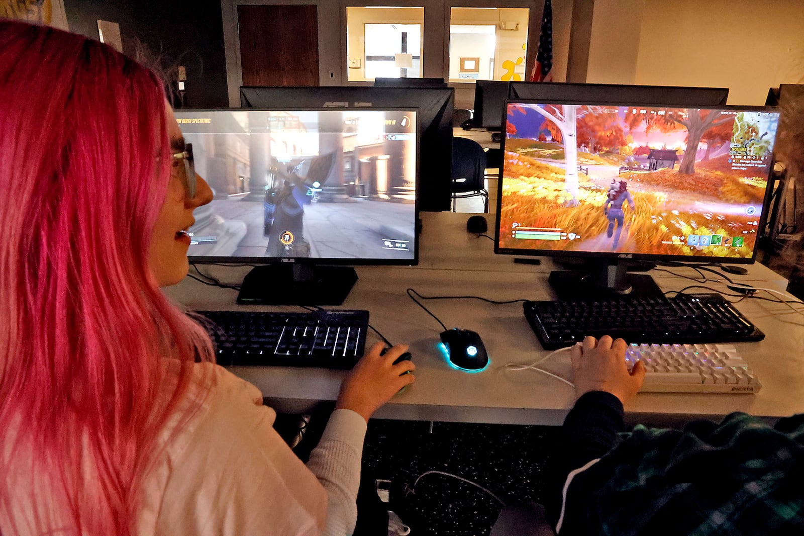 Elise Hess, left, a student at the Gobal Impact STEM Academy, plays computer games in the school's esports computer lab Thursday, Feb. 2, 2023. BILL LACKEY/STAFF