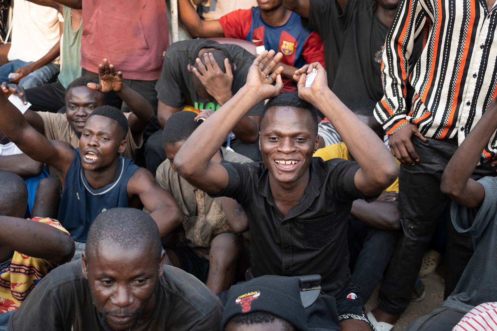 Some of the 600 prisoners released from Democratic Republic of the Congo's capital Kinshasa's Makala Central Prison react Saturday, Sept. 21, 2024. (AP Photo/Samy Ntumba Shambuyi)