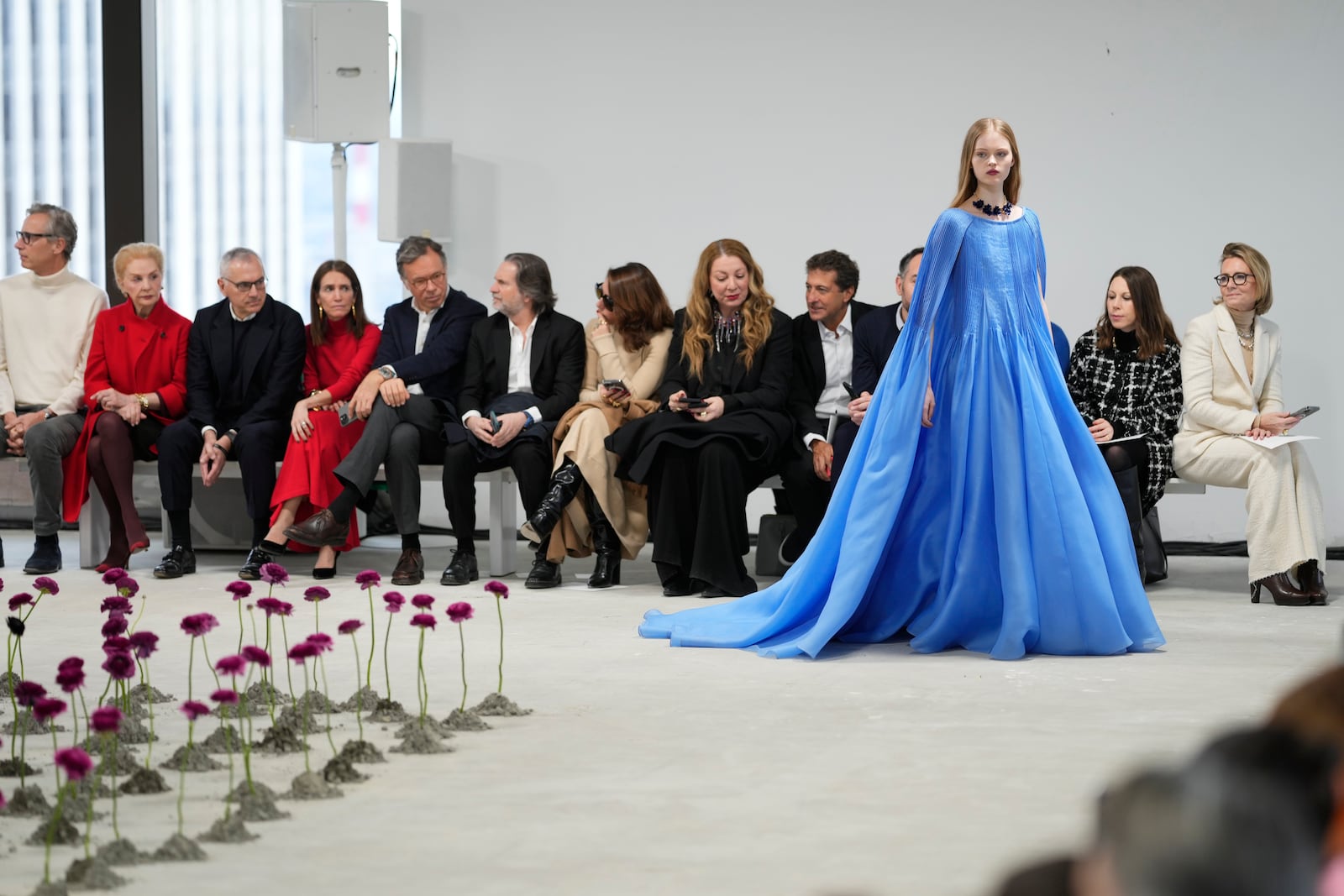 Carolina Herrera, second from left, looks on as a model walks the runway during the Carolina Herrera Fall/Winter 2025 fashion show as part of New York Fashion Week on Monday, Feb. 10, 2025, in New York. (Photo by Charles Sykes/Invision/AP)