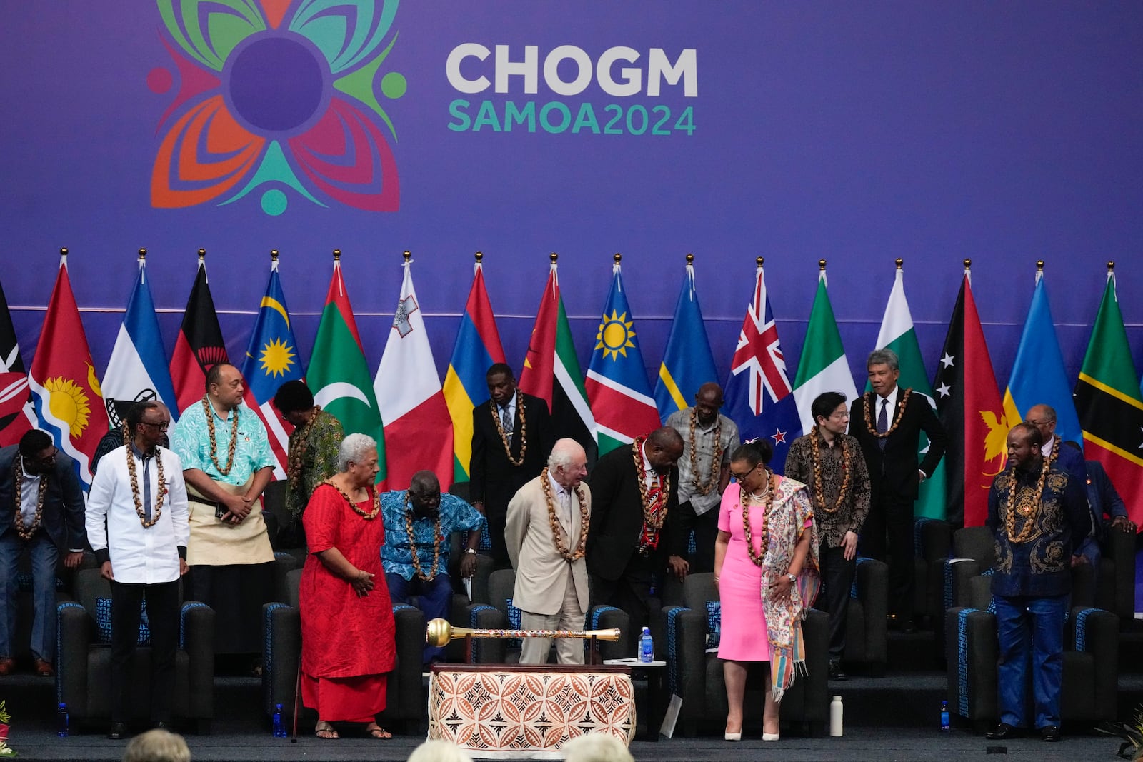 Britain's King Charles, centre, stands with delegates during the opening ceremony for the Commonwealth Heads of Government meeting in Apia, Samoa, Friday, Oct. 25, 2024. (AP Photo/Rick Rycroft/Pool)