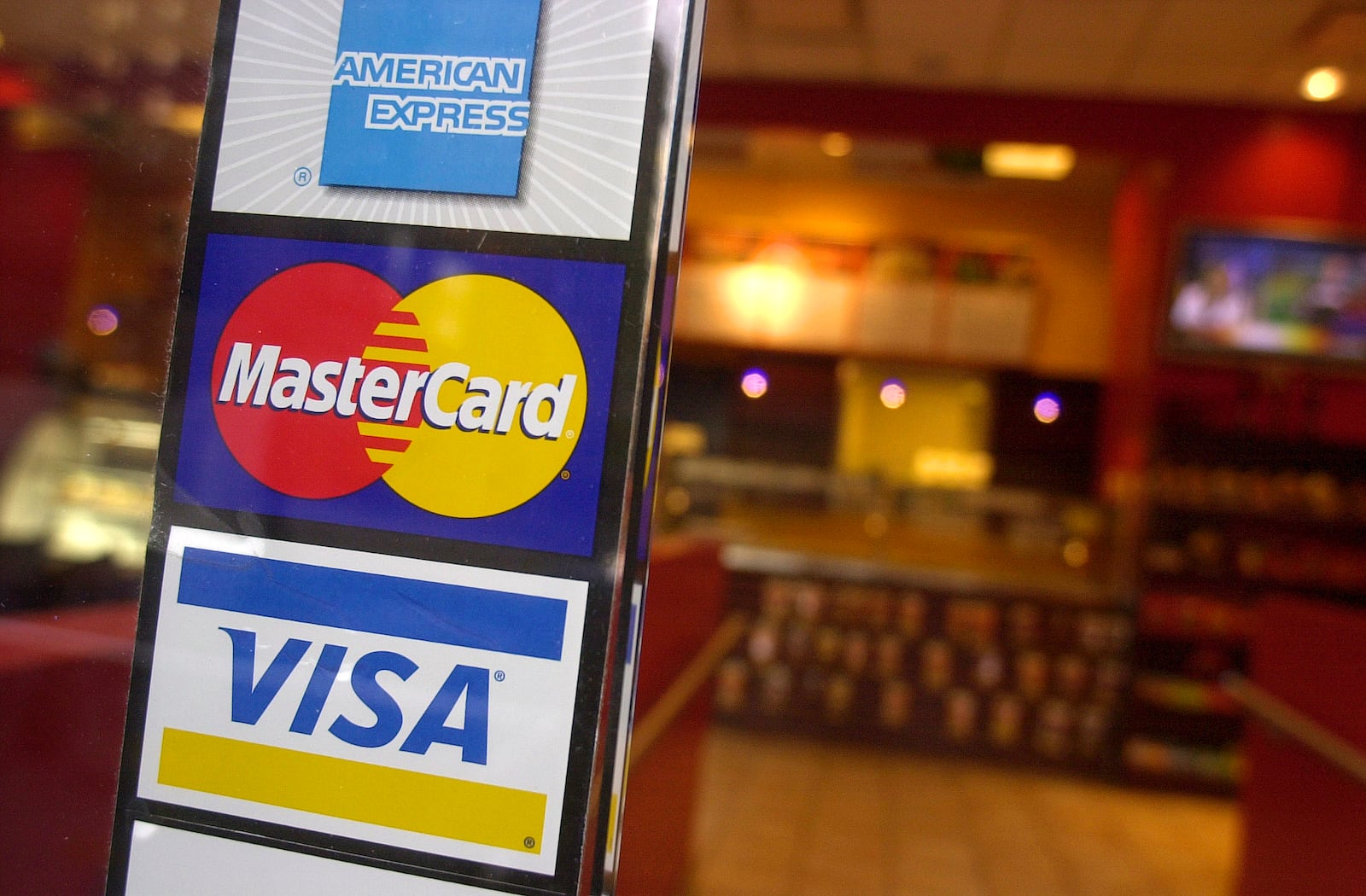 ** FILE ** In a file photo signs for American Express, MasterCard and Visa credit cards are shown at the entrance to a coffee shop (AP Photo/Mark Lennihan)