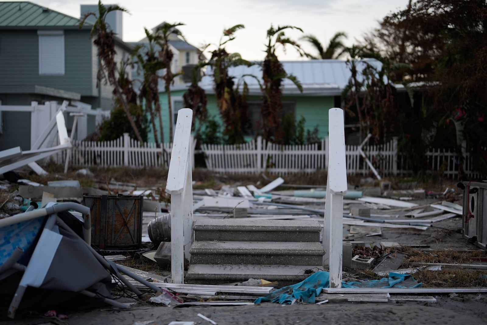 Front steps remain standing after a home was swept, largely intact, onto the neighboring lot following the passage of Hurricane Milton, on Manasota Key, Fla., Saturday, Oct. 12, 2024. (AP Photo/Rebecca Blackwell)