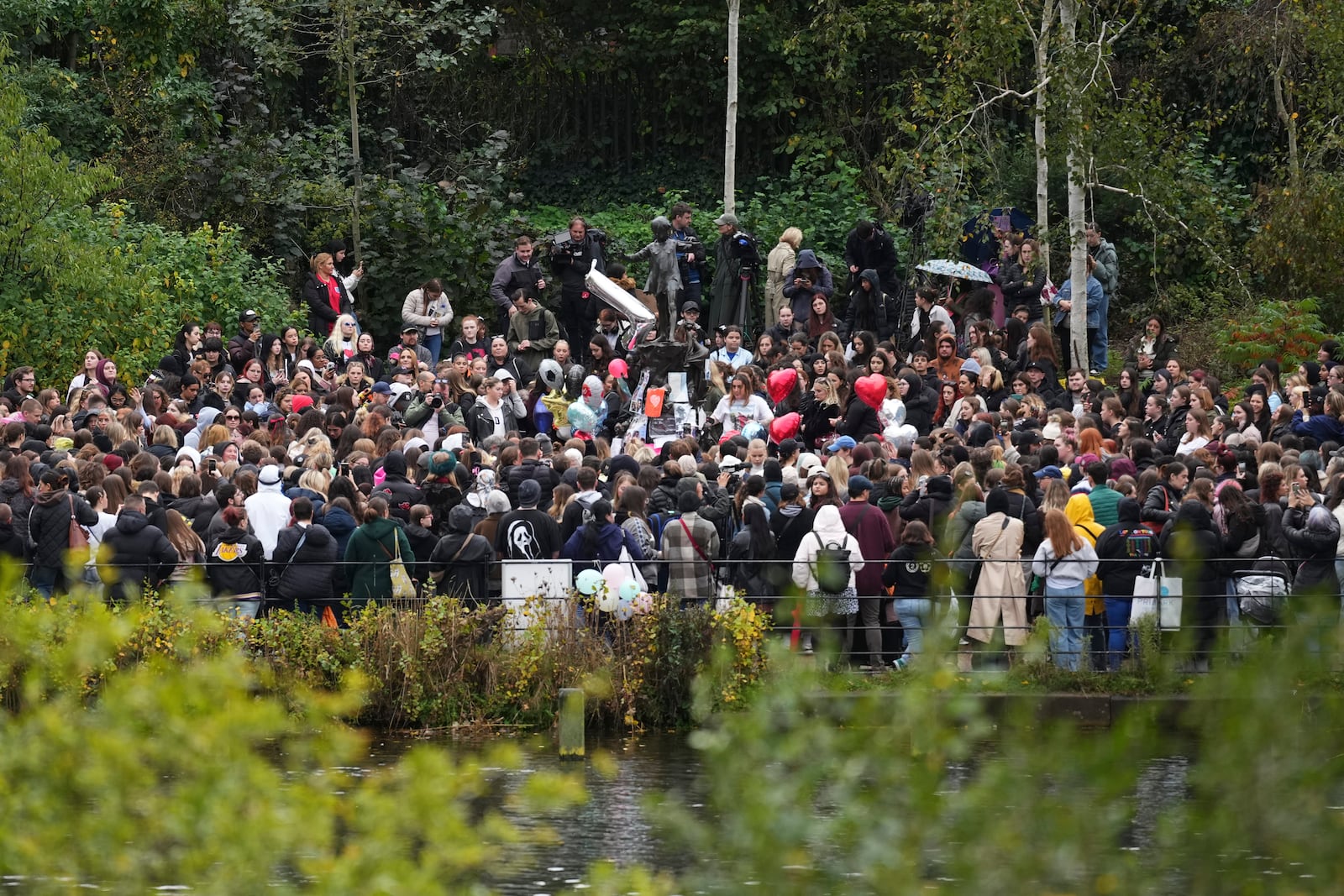 Fans gather to pay tribute to late British singer Liam Payne, former member of the British pop band One Direction in Hyde Park in London, Sunday, Oct. 20, 2024, in London. (Photo by Scott A Garfitt/Invision/AP)