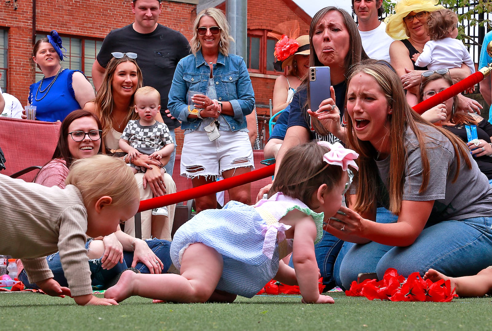 Louisville wasn't the only place to see racing action Saturday, May 6, 2023. Mother Stewart's Brewery held their first ever Crawl For The Roses as part of their Derby Day event celebrating the running of the Kentucky Derby. Instead of horses, however, Mother Stewart's race featured babies. Two heats of parents released their tiny thoroughbreds and cheered them on as they raced on all fours to the waiting arms of the other parent. Liam Zawada, 14-months, was the winner of the championship heat. He and his mother received an award for being the first Crawl for the Roses champion. BILL LACKEY/STAFF