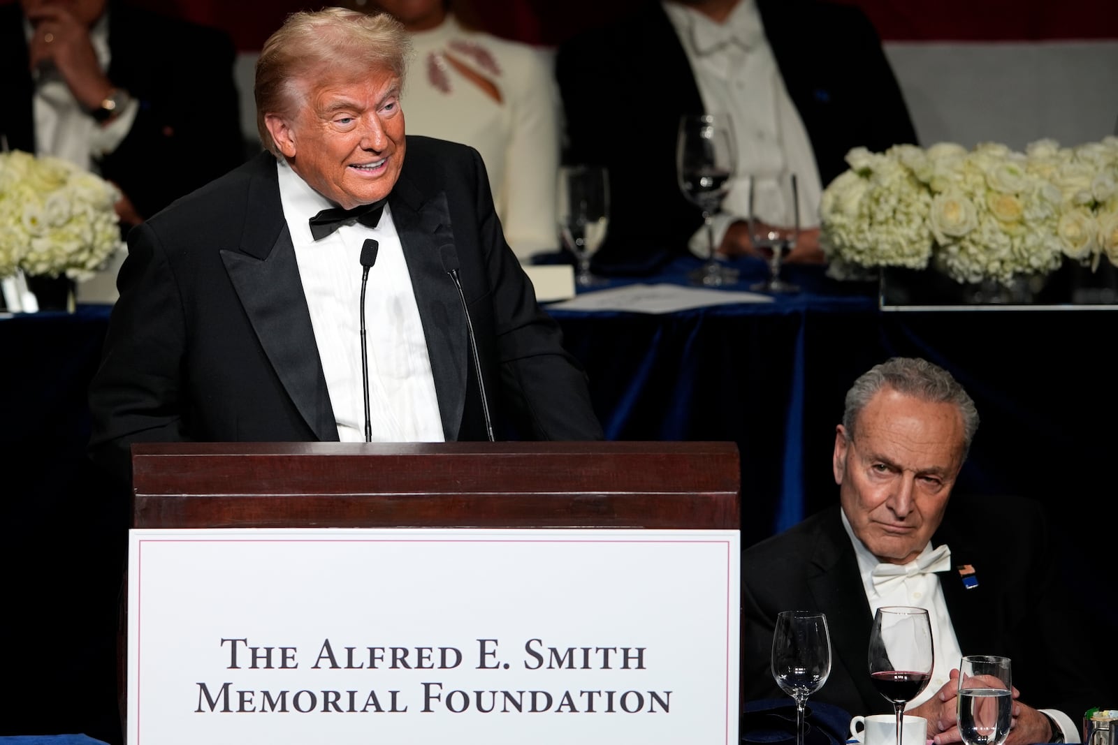 Republican presidential nominee former President Donald Trump speaks as Senate Majority Leader Chuck Schumer of N.Y., listens at the 79th annual Alfred E. Smith Memorial Foundation Dinner, Thursday, Oct. 17, 2024, in New York. (AP Photo/Julia Demaree Nikhinson)